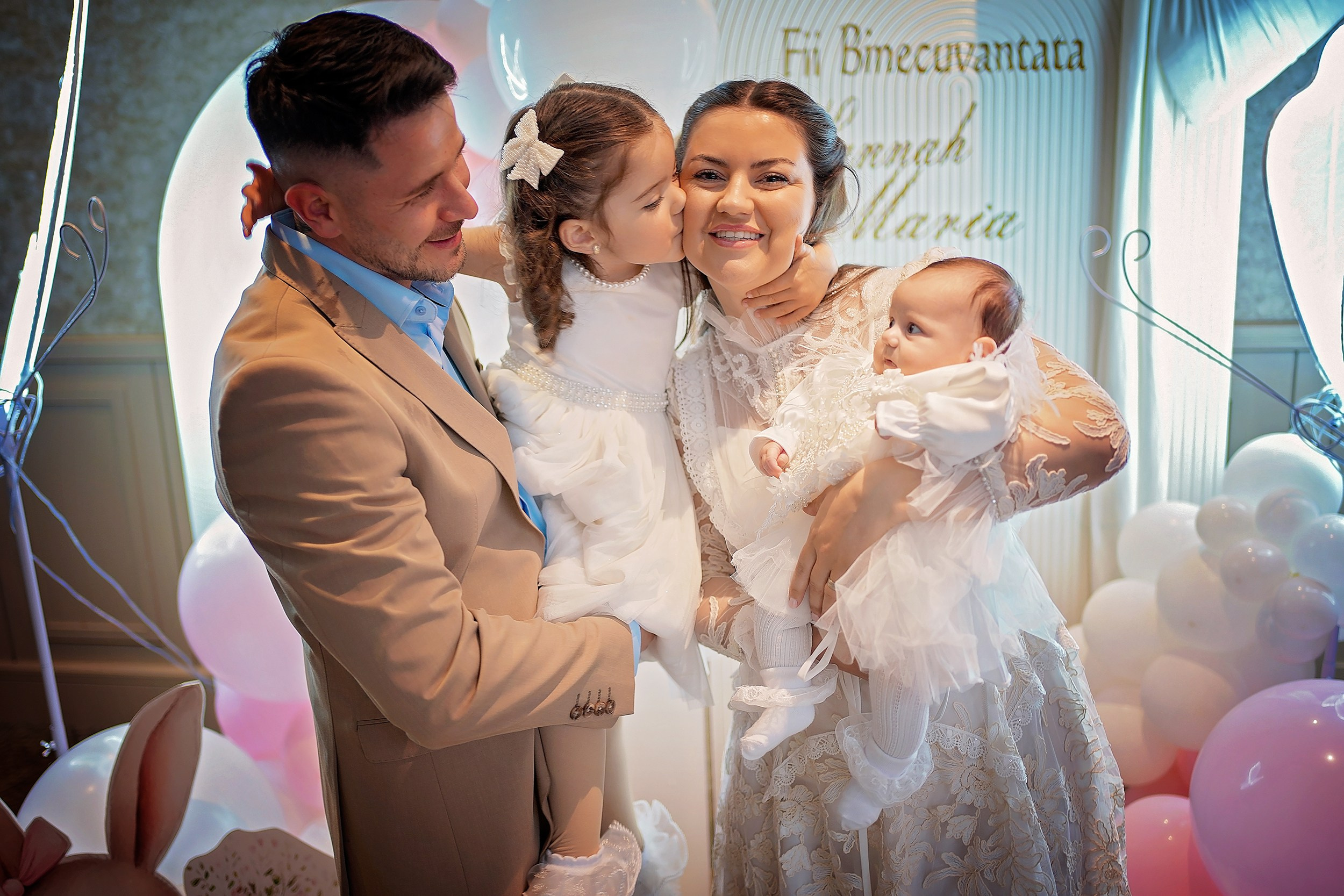 Family standing together at a Munster christening celebration.