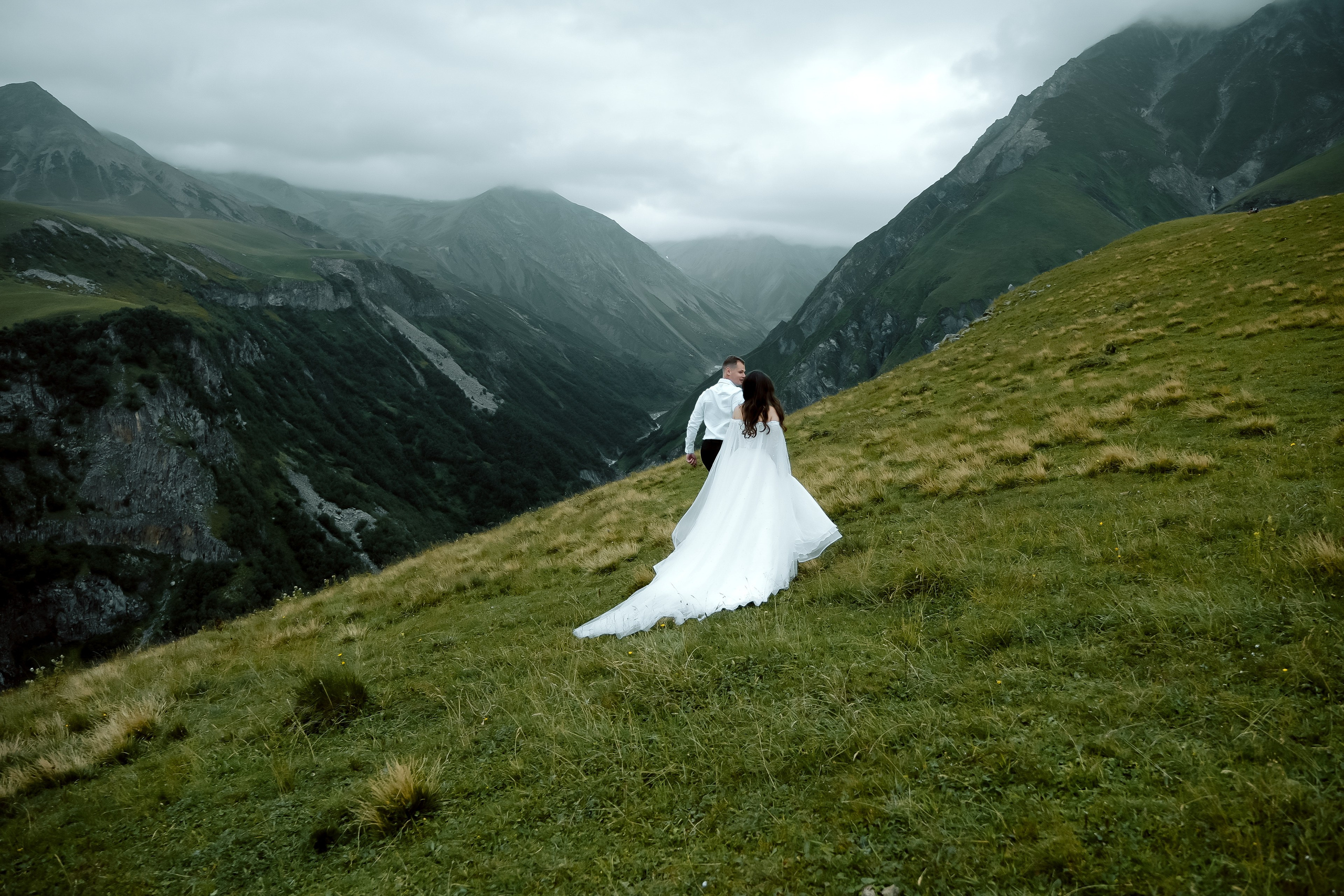 Couple running in the stormy mountain light in Gudauri