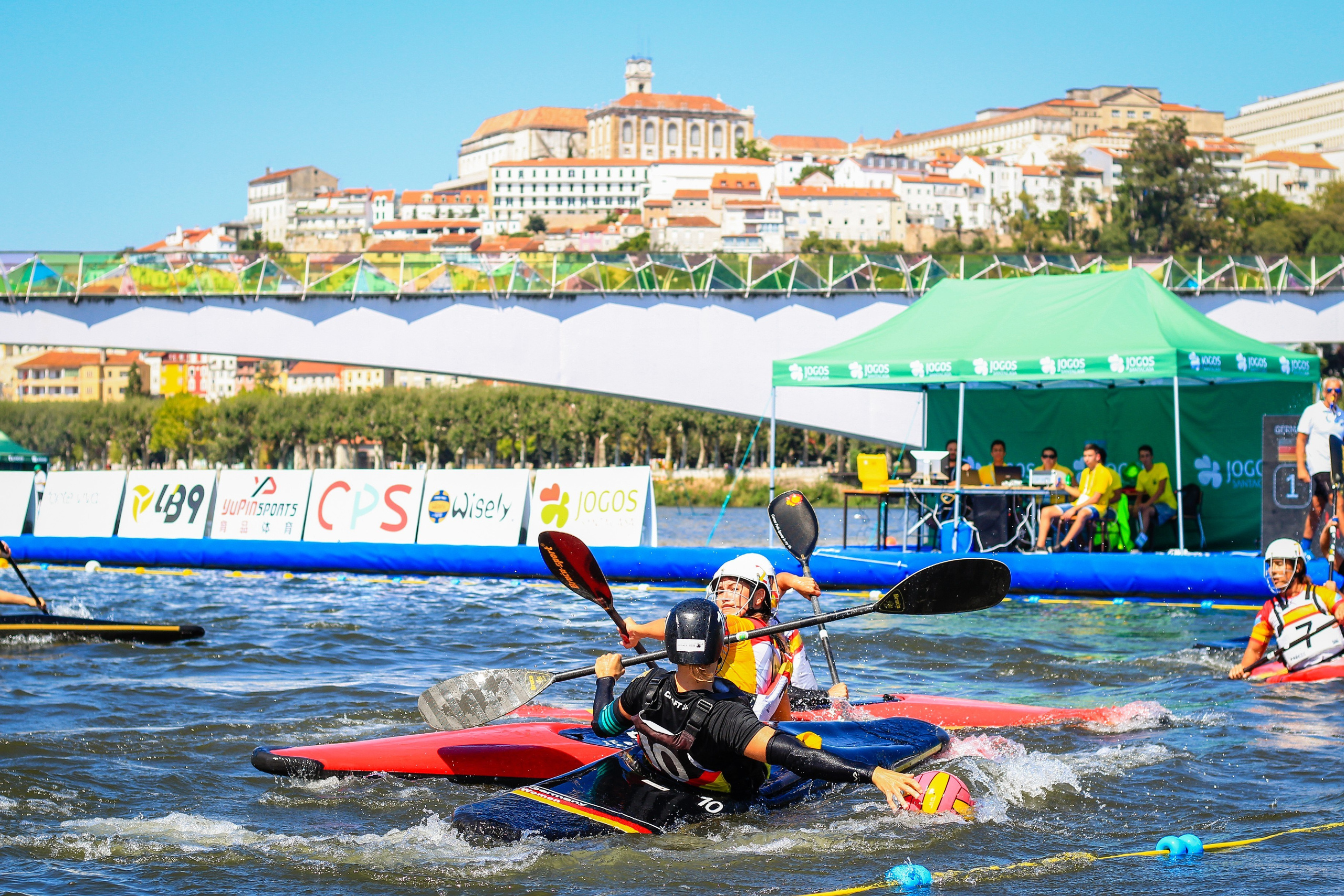 Player at ECA European Canoe Polo Coimbra 2019 with Coimbra University in the background