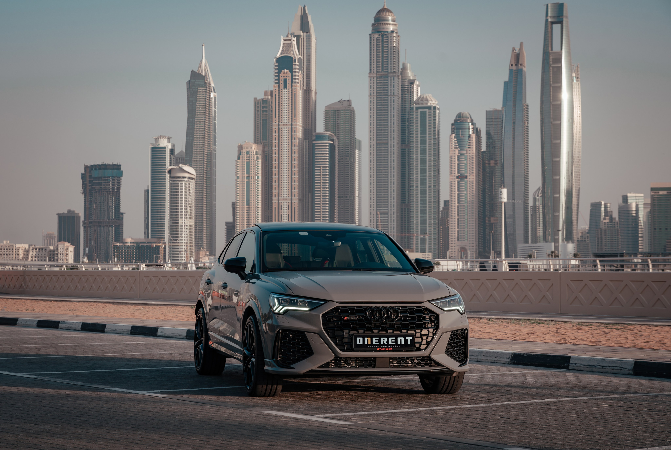 Grey Audi on the background of skyscrapers in Dubai Marina