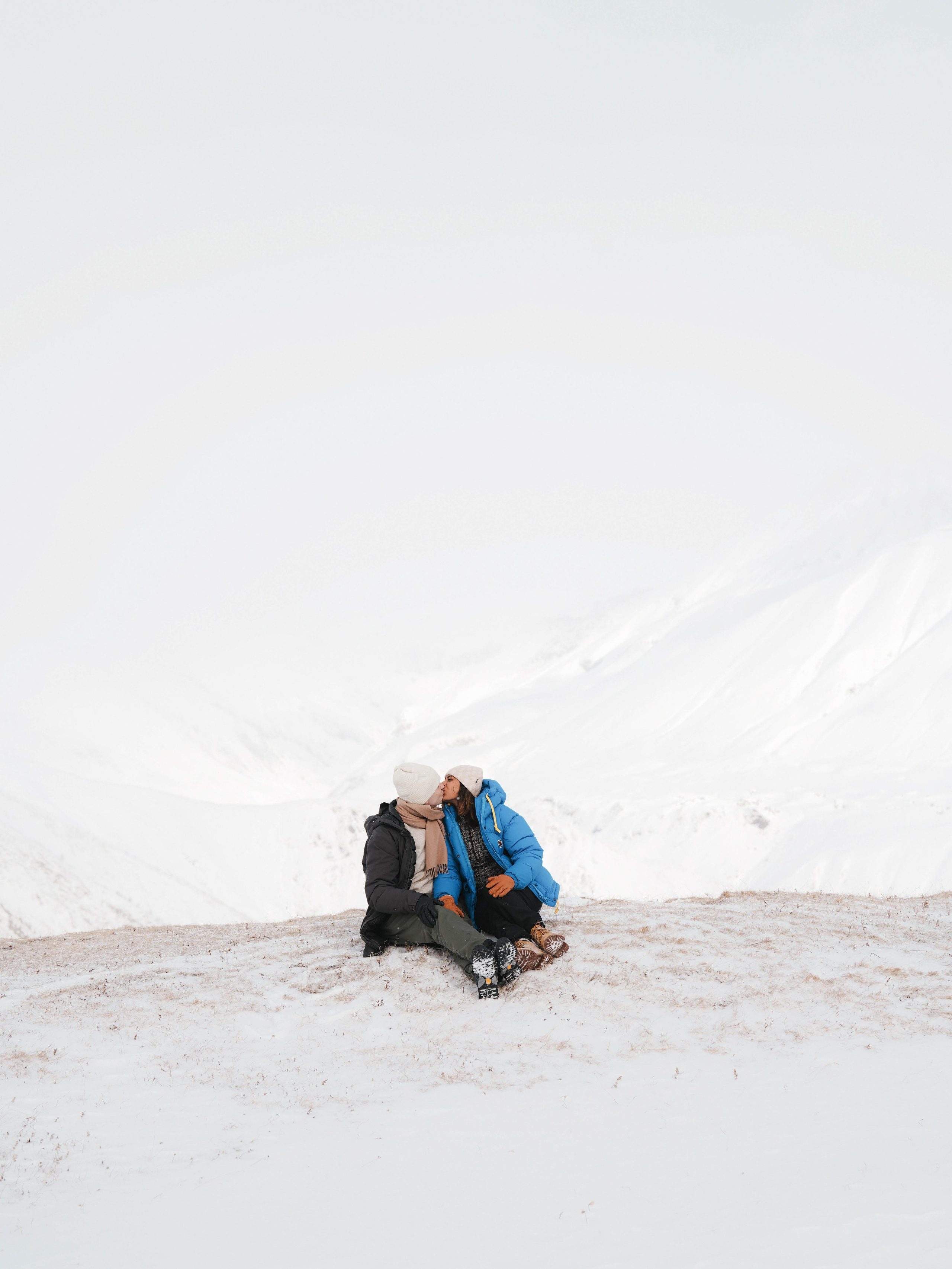 Couple sitting with mountain view in Gudauri