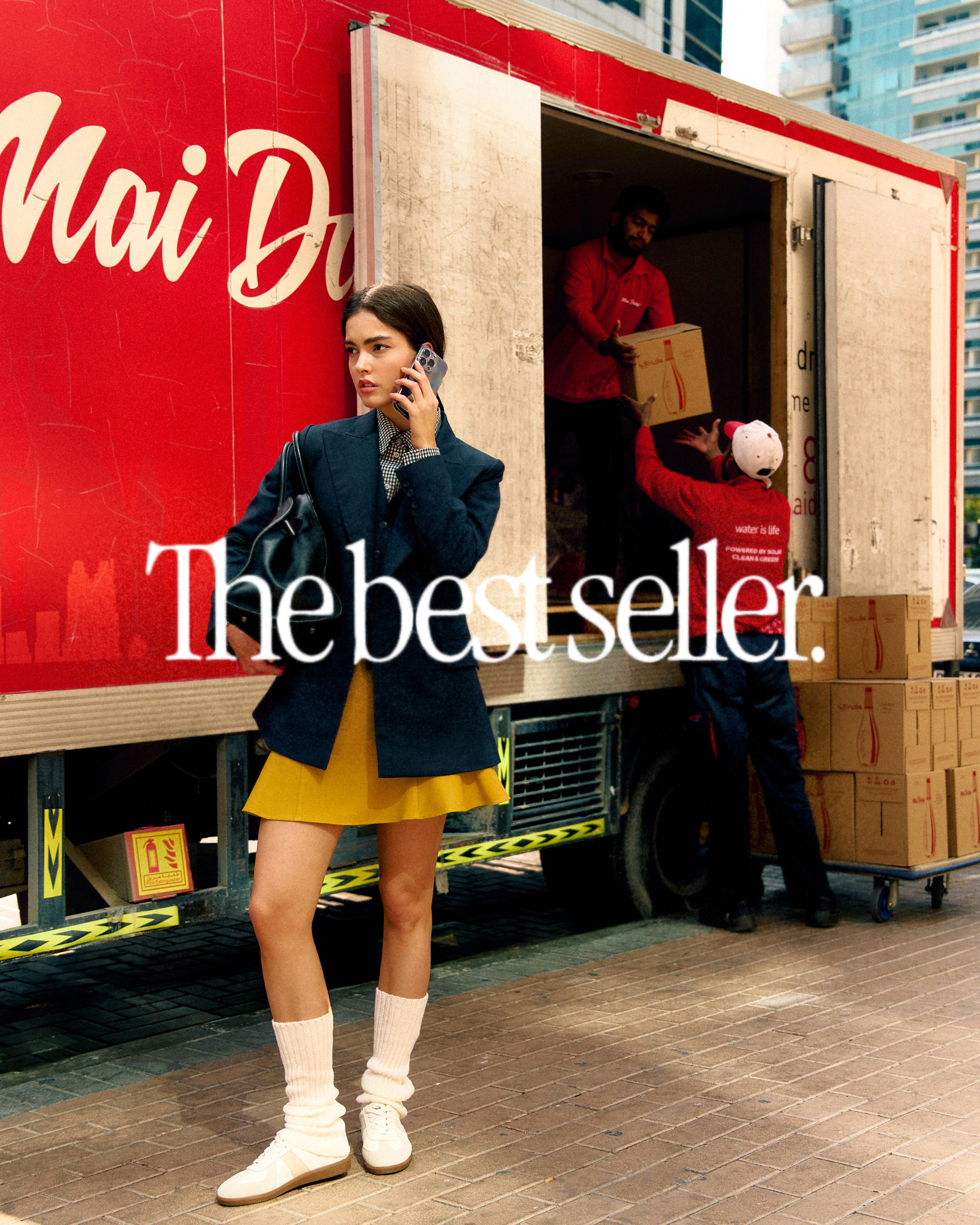 Model posing near storefront in casual streetwear, daytime city vibe