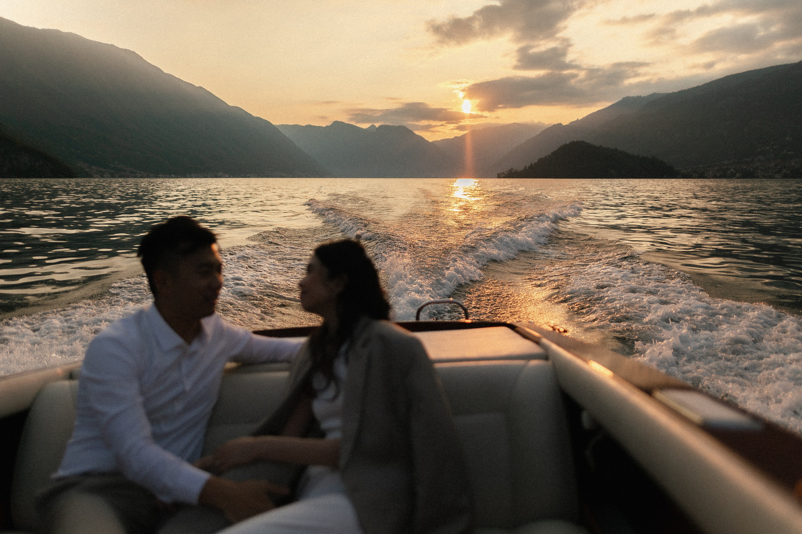 Bride and groom on a boat at Lake Como at sunset