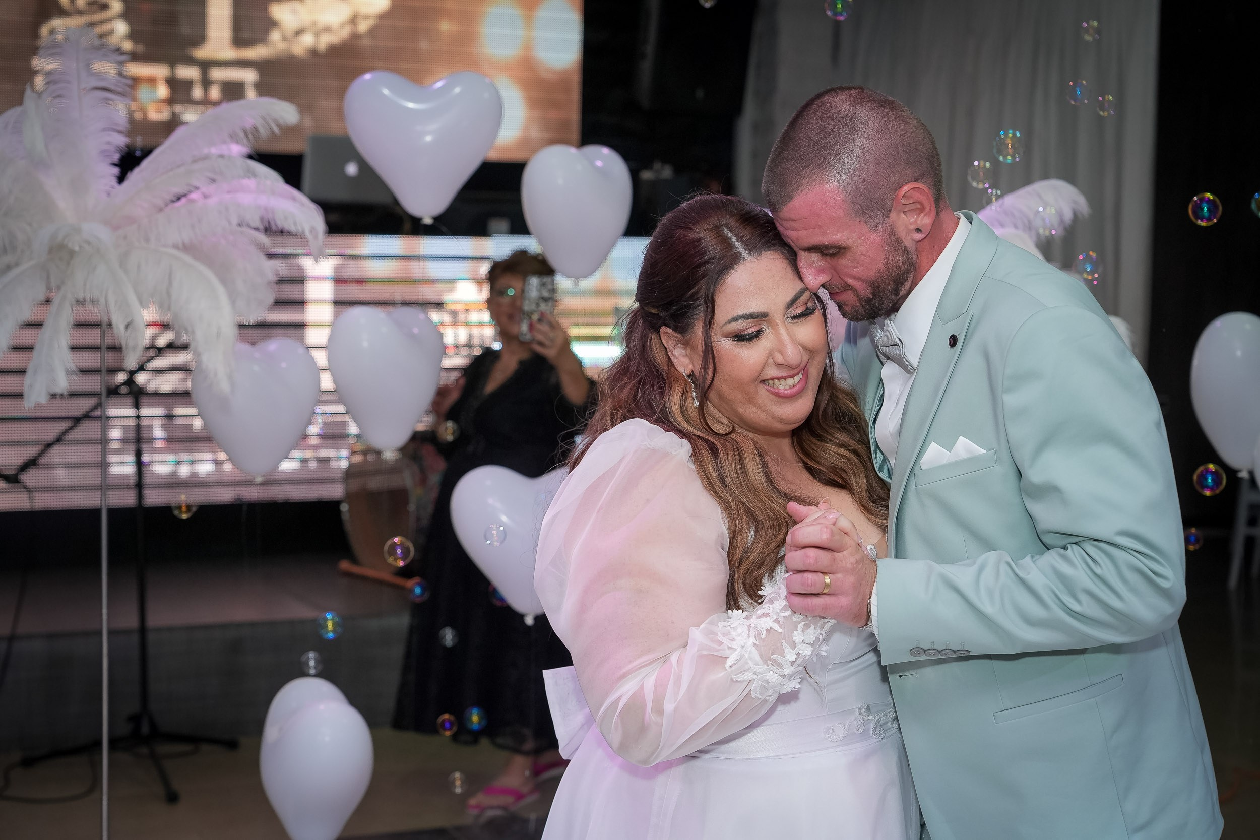 Ella and Matan share their first dance surrounded by heart-shaped balloons