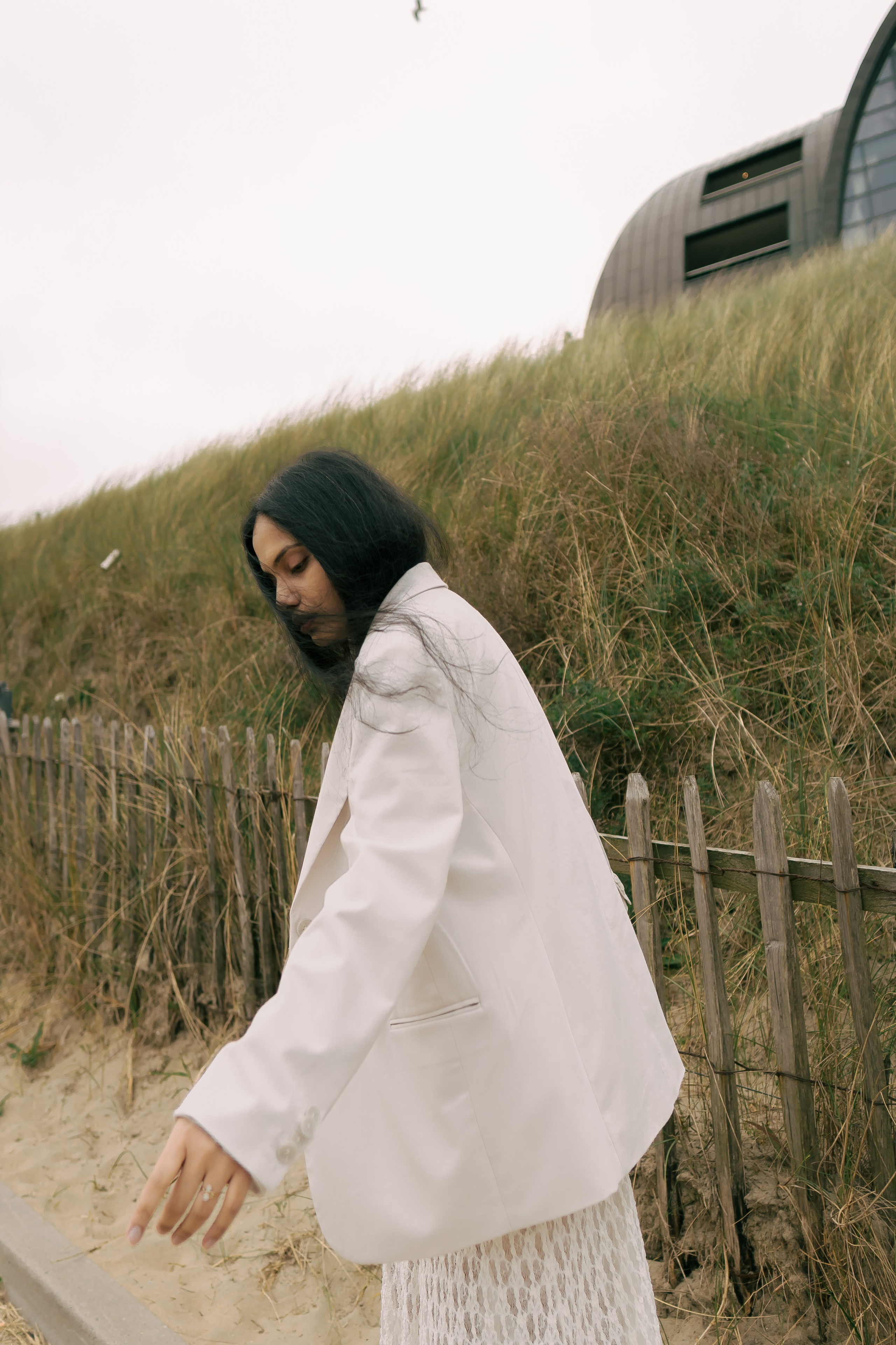 Fashion photoshoot in dunes with lace skirt 