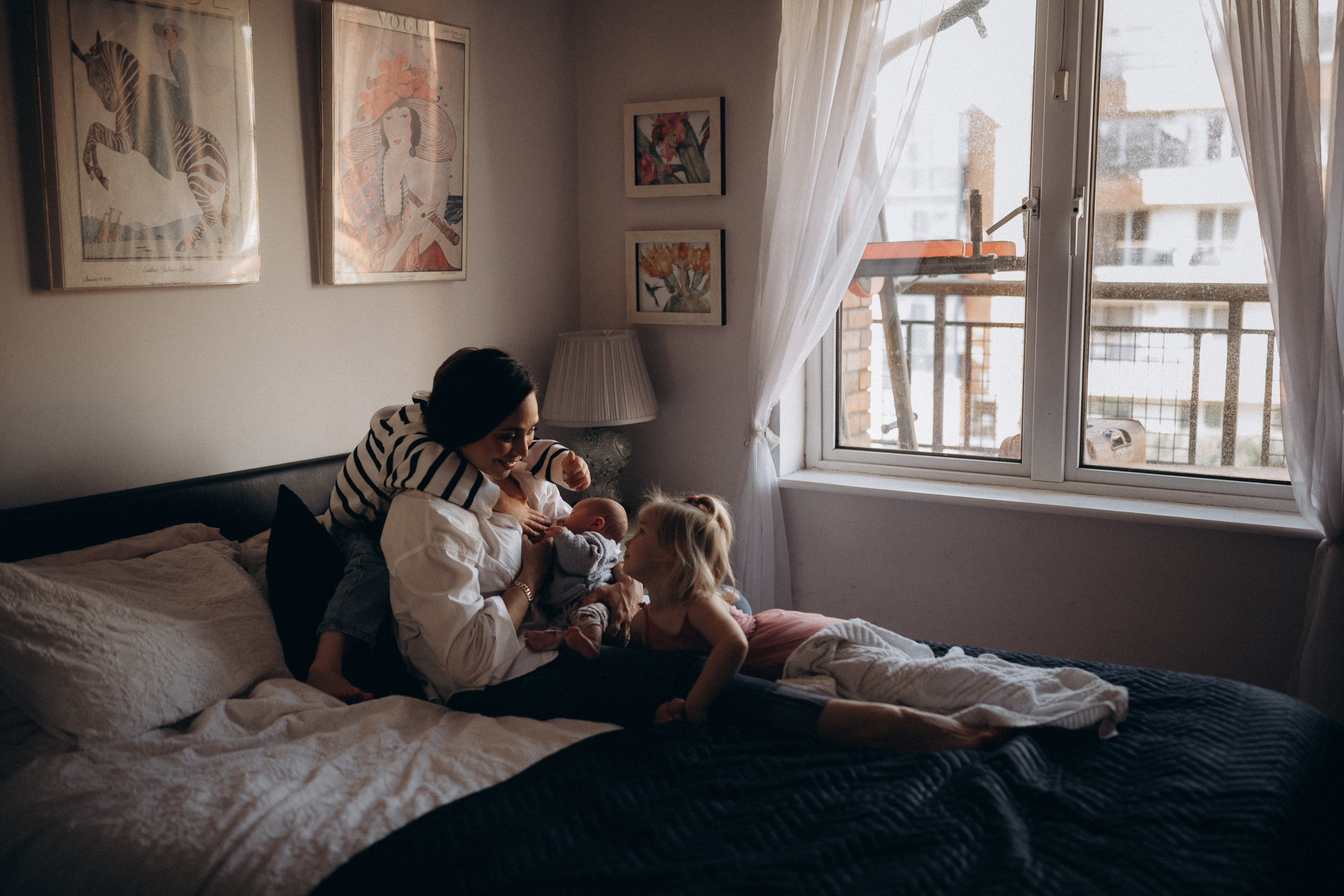 mother feeding newborn baby at home