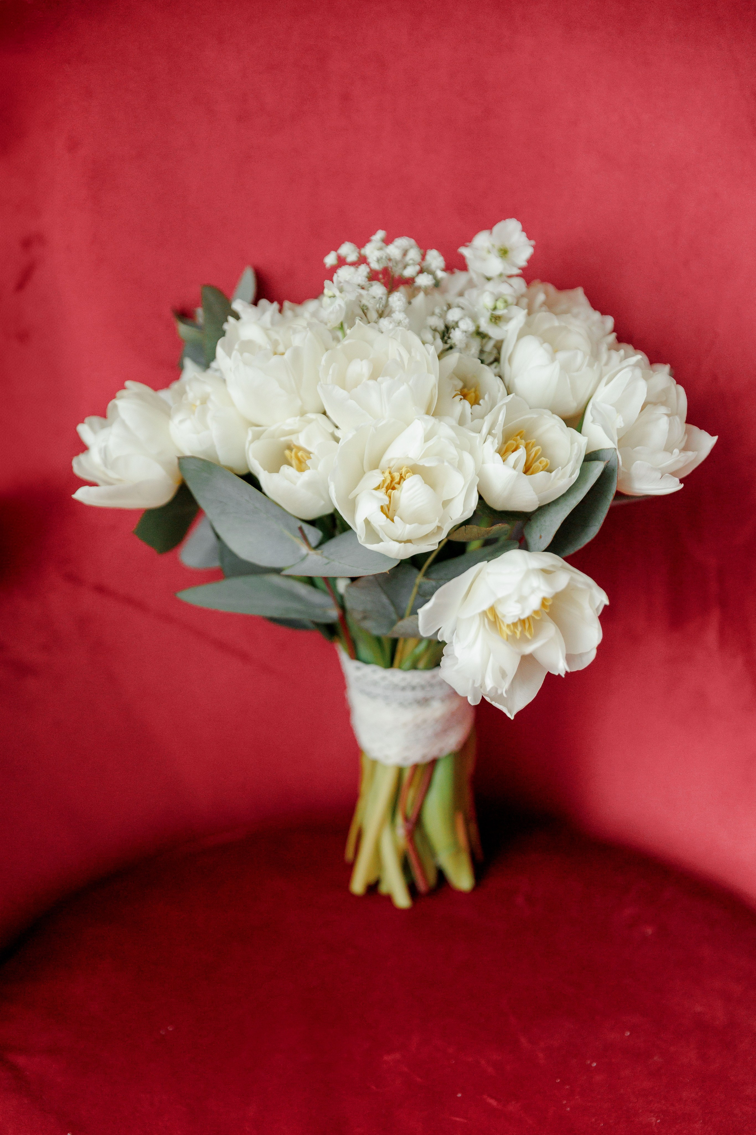 Close-up of a bride's bouquet against the scenic chair highlighting the beauty of the venue in France.