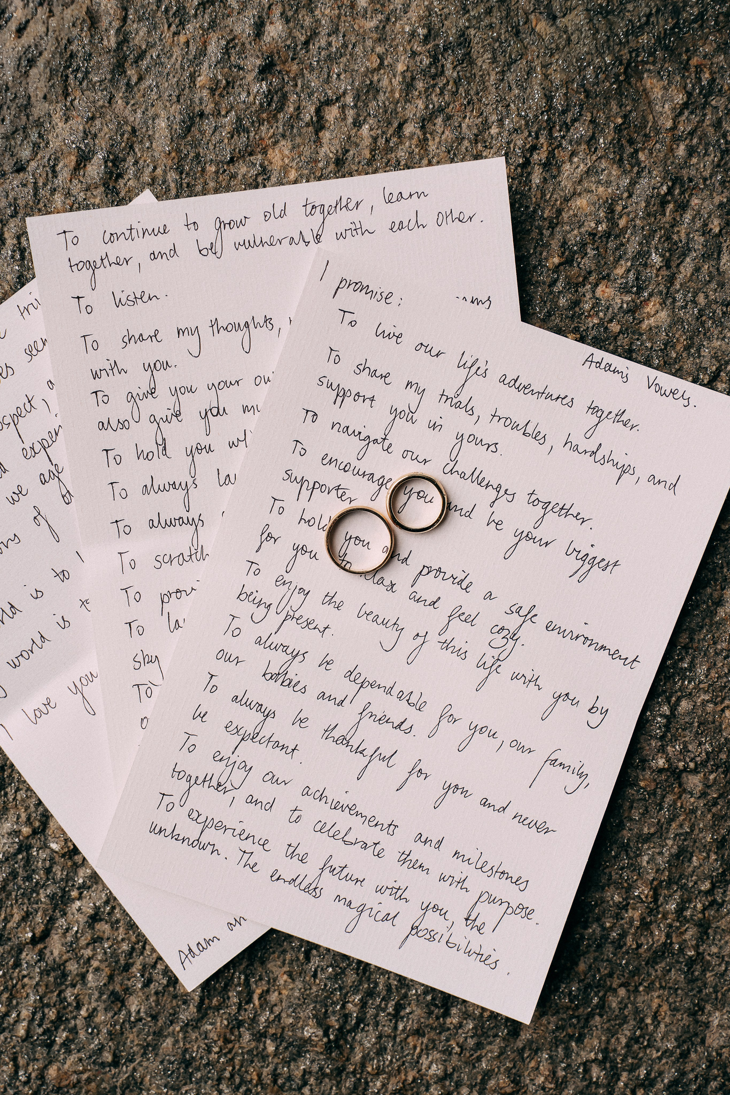 Handwritten wedding vows and rings on a stone ledge at Villa Lario, Lake Como, Italy
