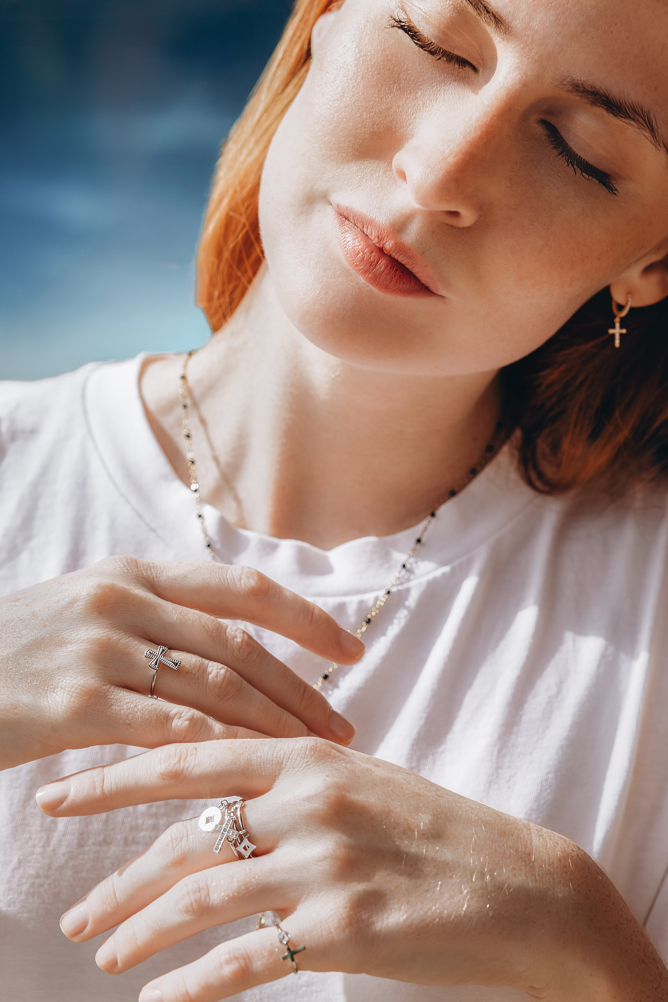 Artistic brand portrait showcasing minimalist cross jewelry and delicate rings during a natural light product photoshoot in Valencia, Spain — perfect for brands seeking high-quality content and product photography in Valencia or across Spain.