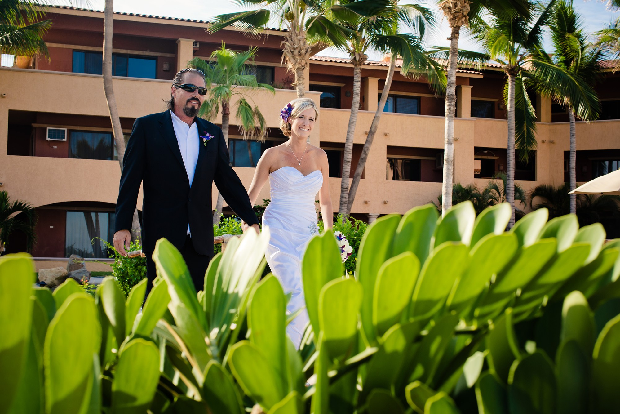 Elopement in Los Cabos Mexico – bride and groom walking hand in hand at sunset, intimate beach wedding photography in Cabo San Lucas