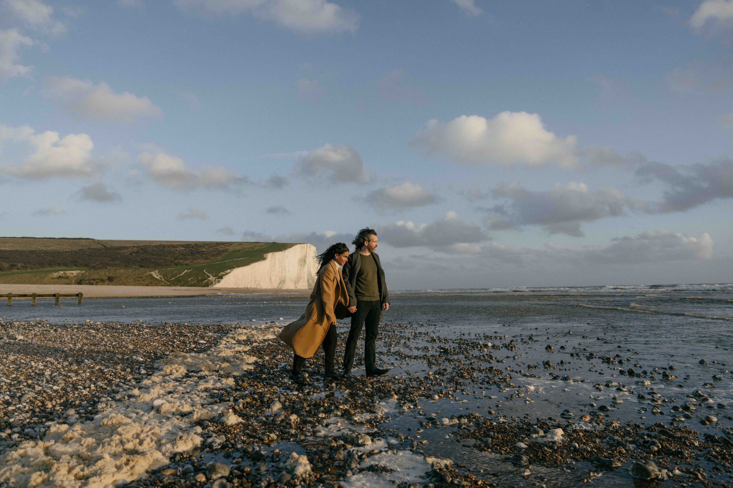 couple with white cliffs seven sisters england engagement photos