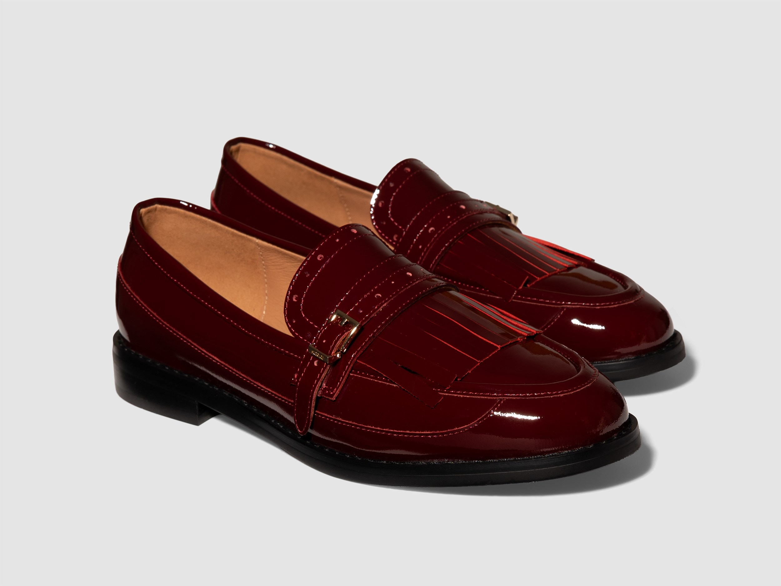 Burgundy patent loafers white background glossy footwear product photography