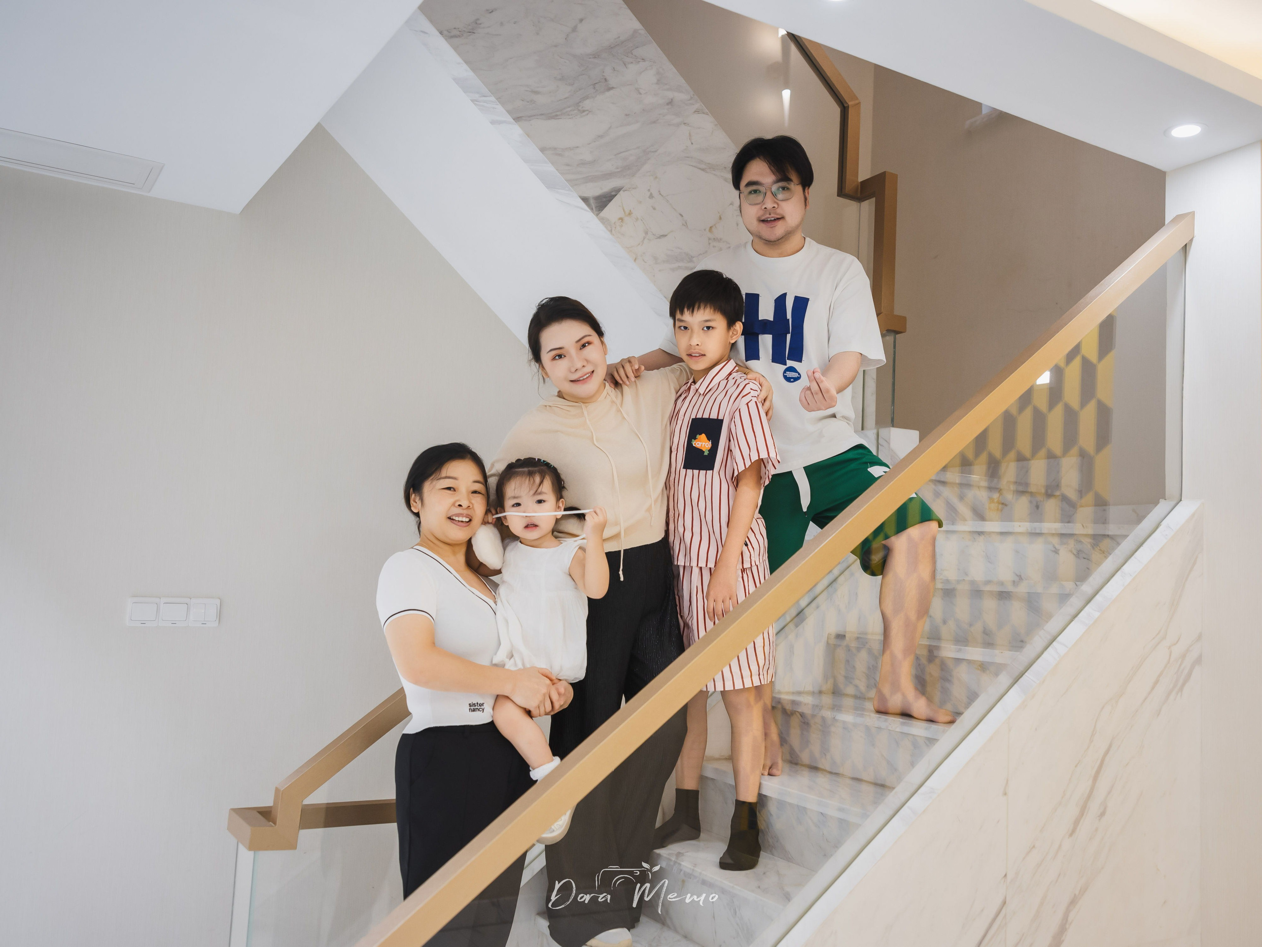  A Shanghai family stands together on the staircase of their nearly empty home before moving abroad.