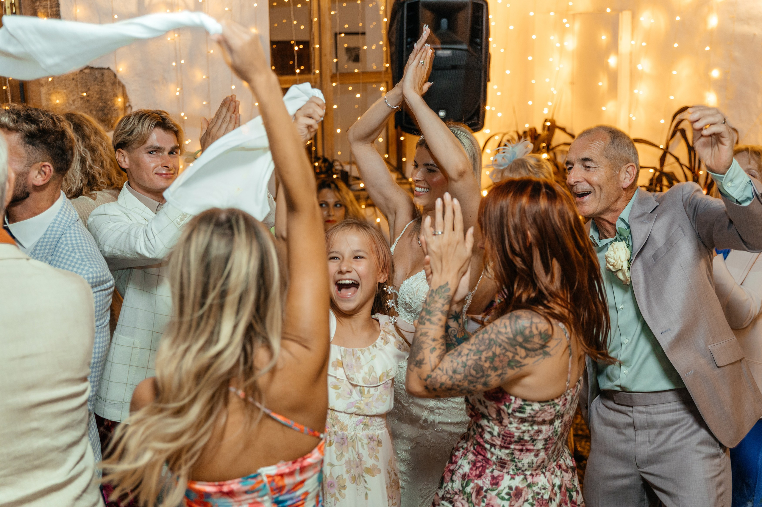 Guests enjoying traditional Greek music and dancing at the wedding party in a lively Lindos restaurant in Rhodes.