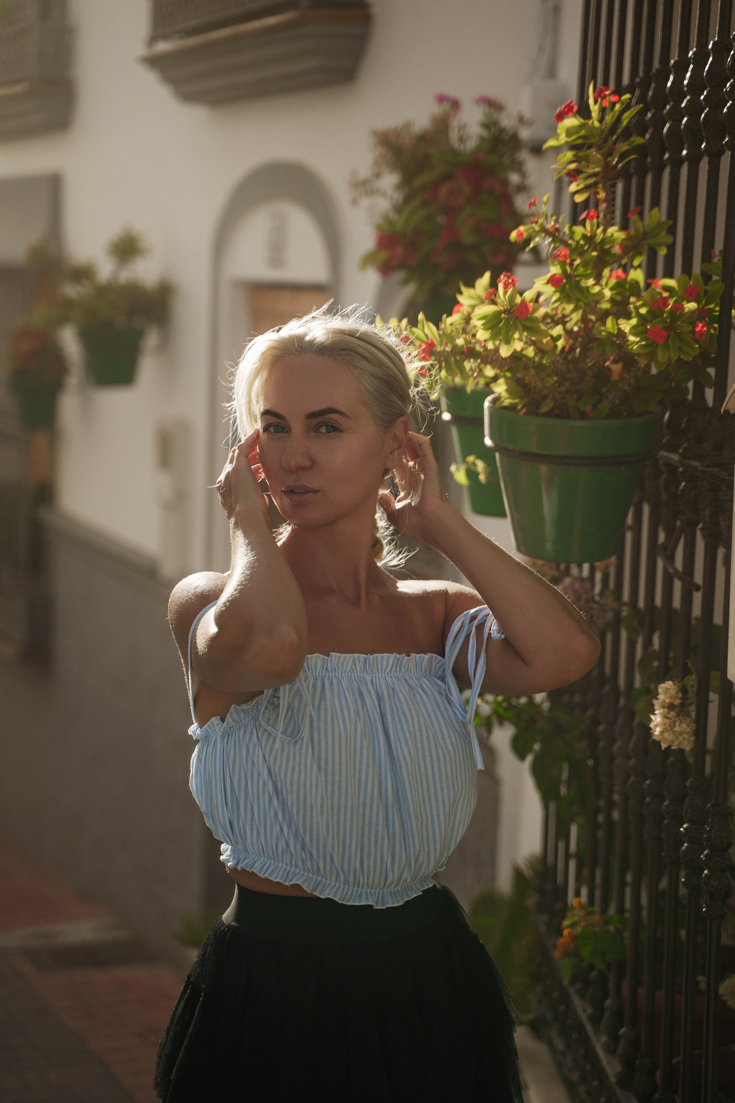 Sophisticated street portrait of an elegant blonde woman in Estepona old town