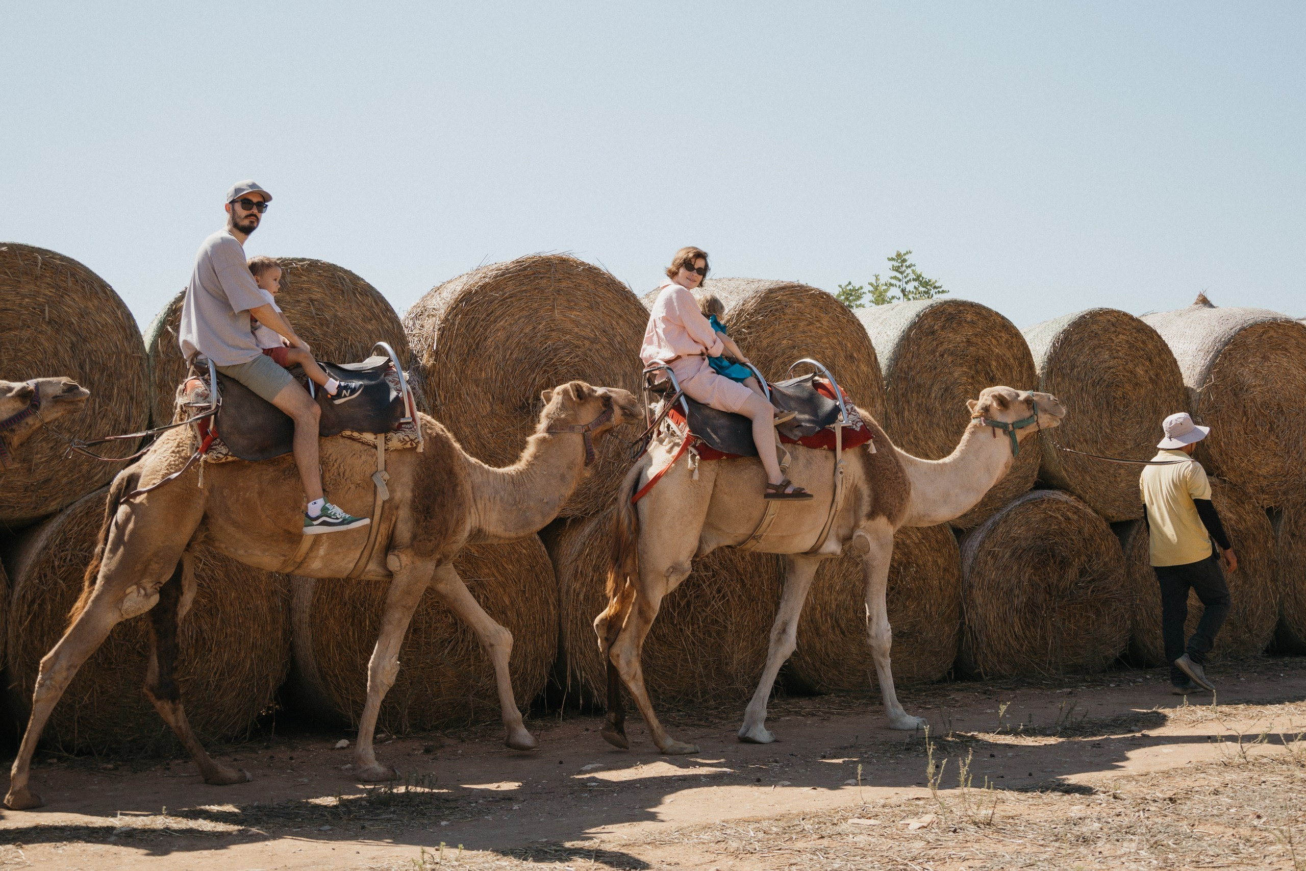 Joyful Moments in Camel park: Olya and Ada’s Day of Fun and Adventure, sliding and riding camels. Photographer in Barcelona capturing unique stories | Kate Chumak
