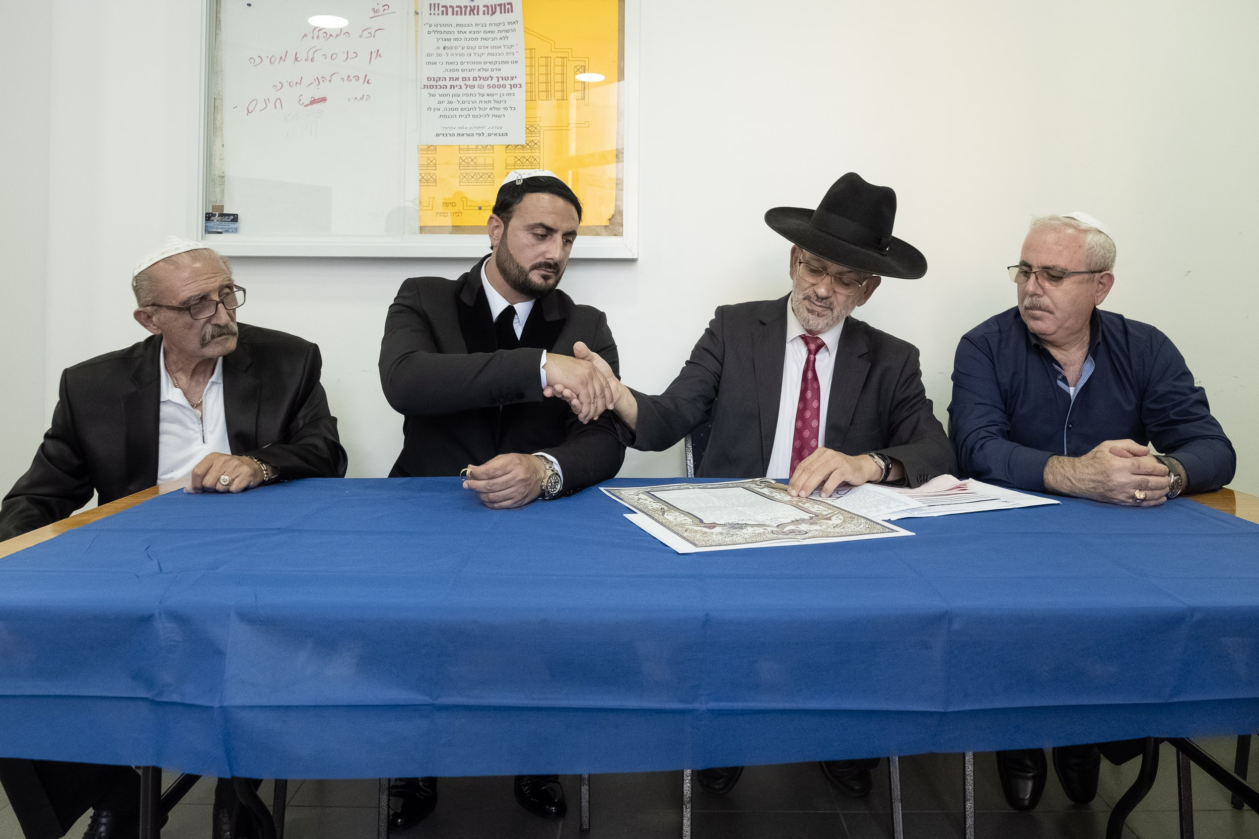 Emil shakes hands with the rabbi before the ketubah signing