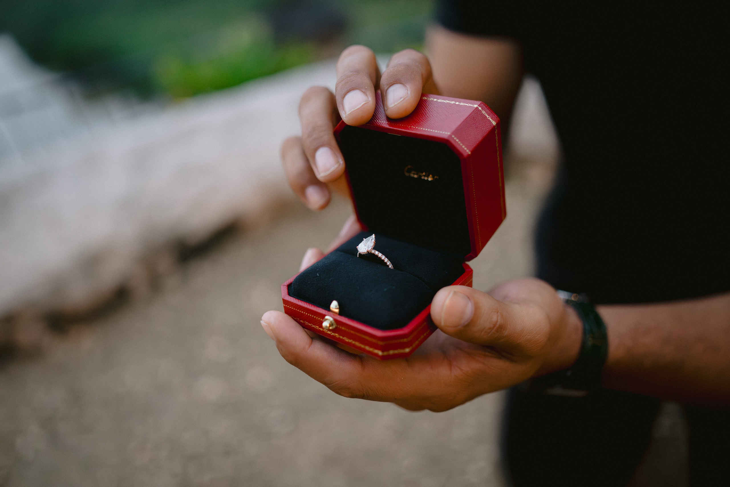 Man proposing to a woman at a scenic overlook with a river valley in the background, surrounded by rustic stone of Altos de chavon. Punta cana wedding family fashion photographer dominican republic, destination wedding photographer, elopement photography Punta Cana
