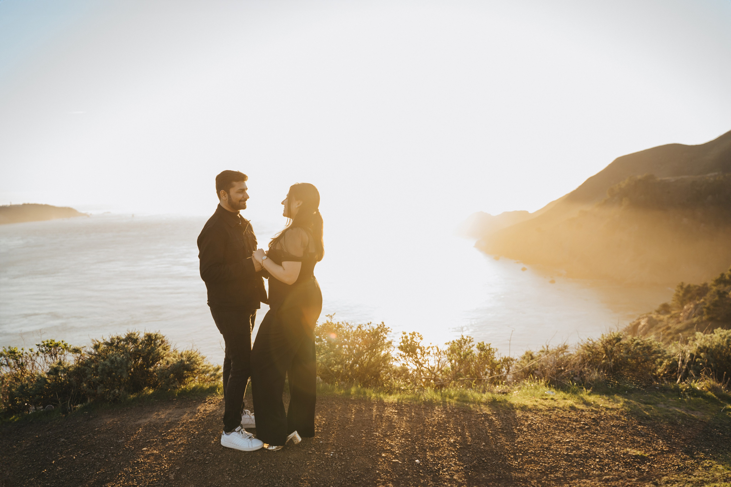 Proposal.  Overlooking the golden San Franisco Bridge sunset with a couple. Photographer Video. 