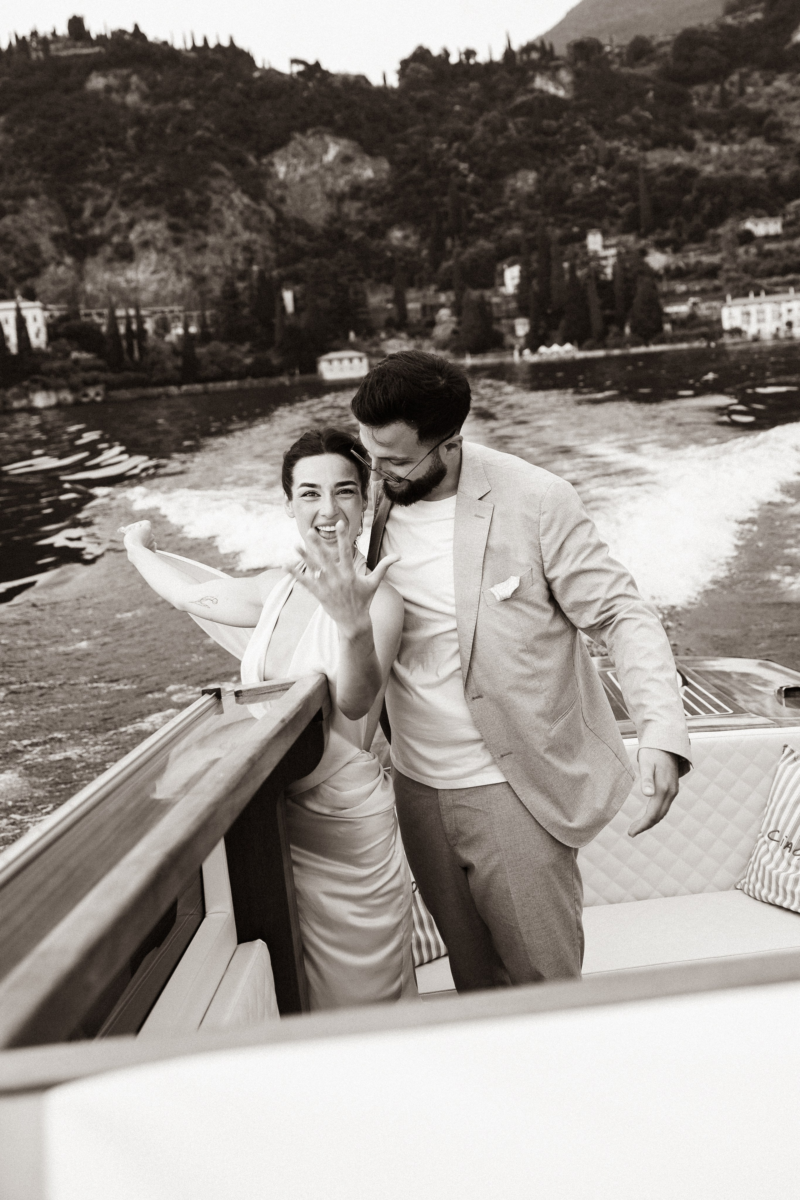 Woman smiling on a private boat during a surprise proposal on Lake Como