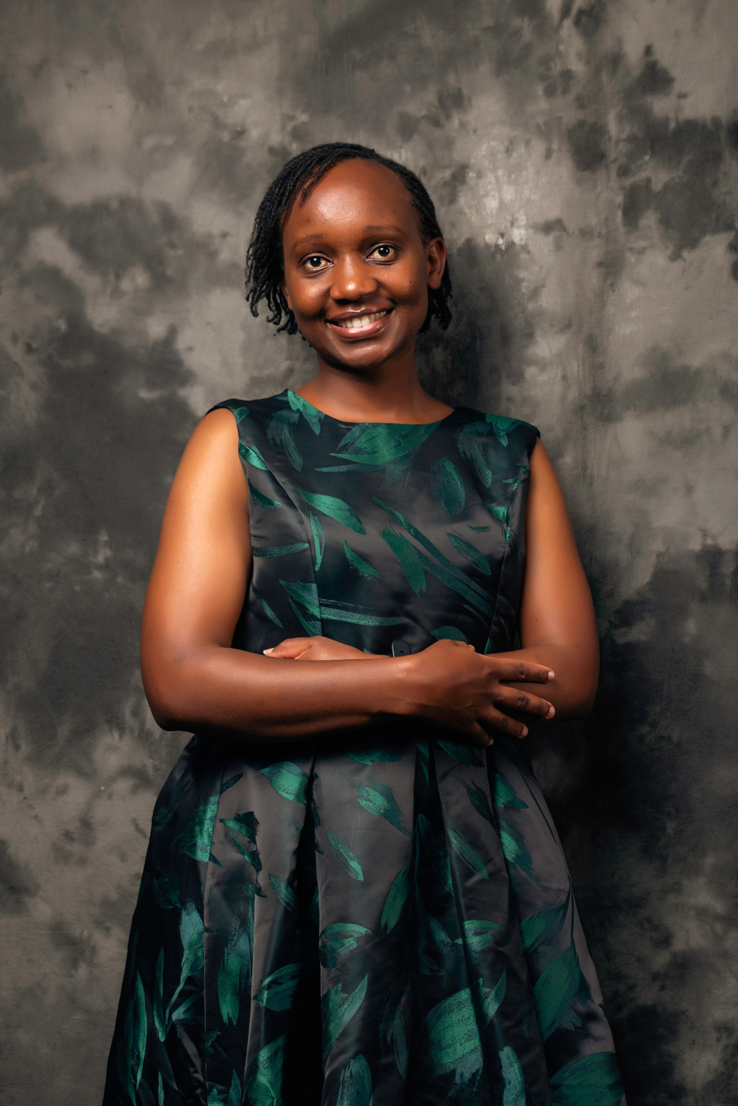 Smiling woman in sleeveless green dress — studio portrait photography by Nick Ouma in Nairobi