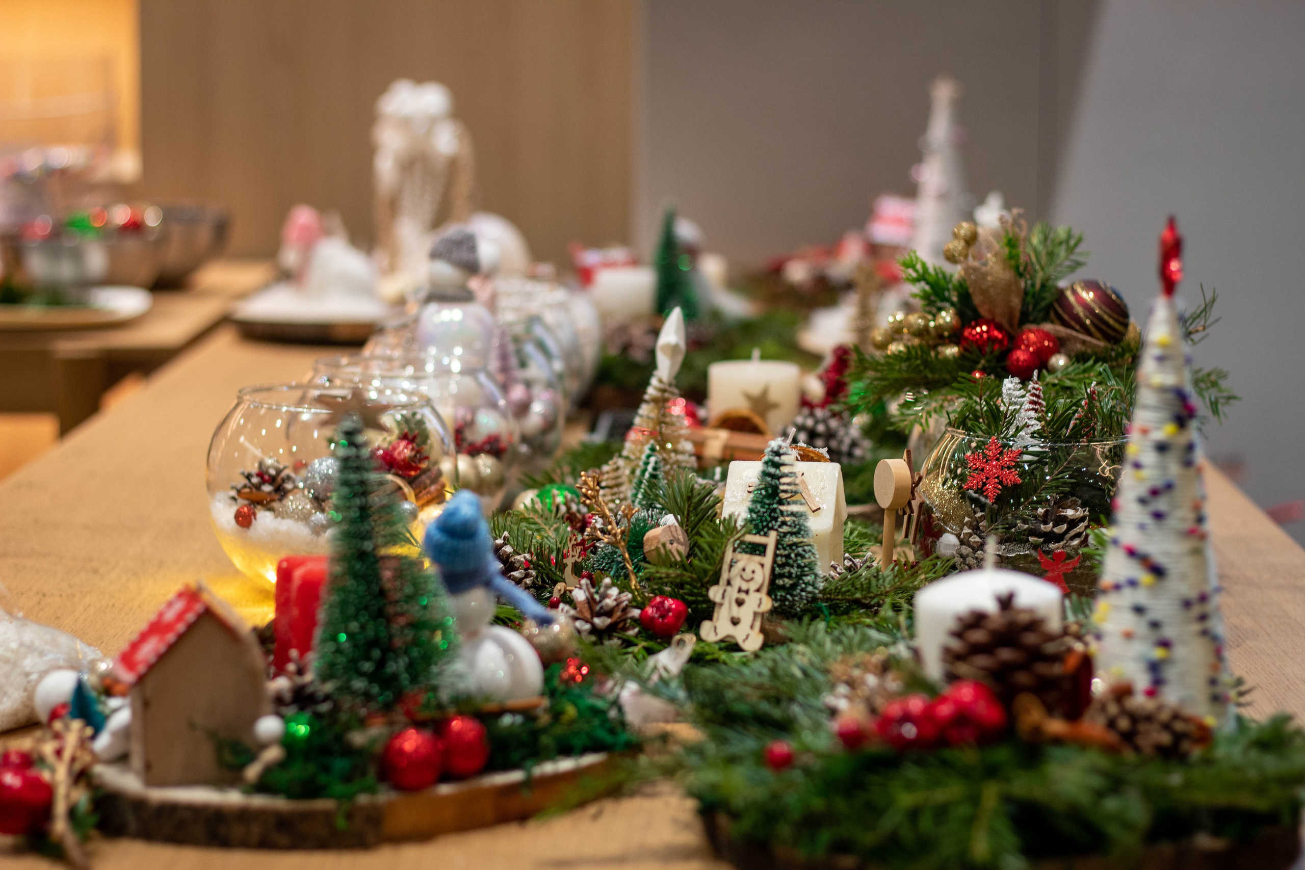Detailed Christmas miniature village with lights, figurines, and holiday trees.