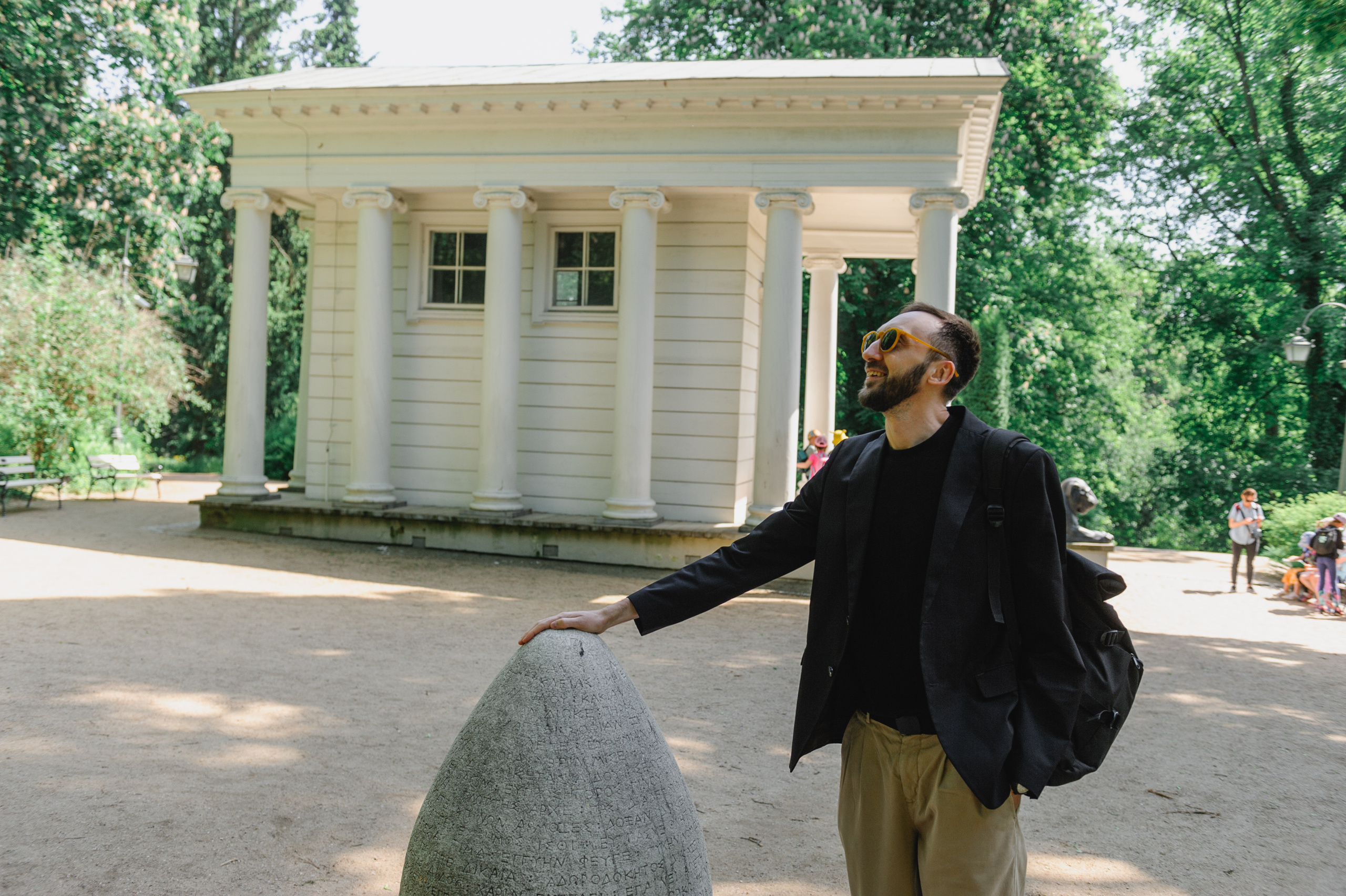 A young man holds onto an egg-shaped stone tablet.