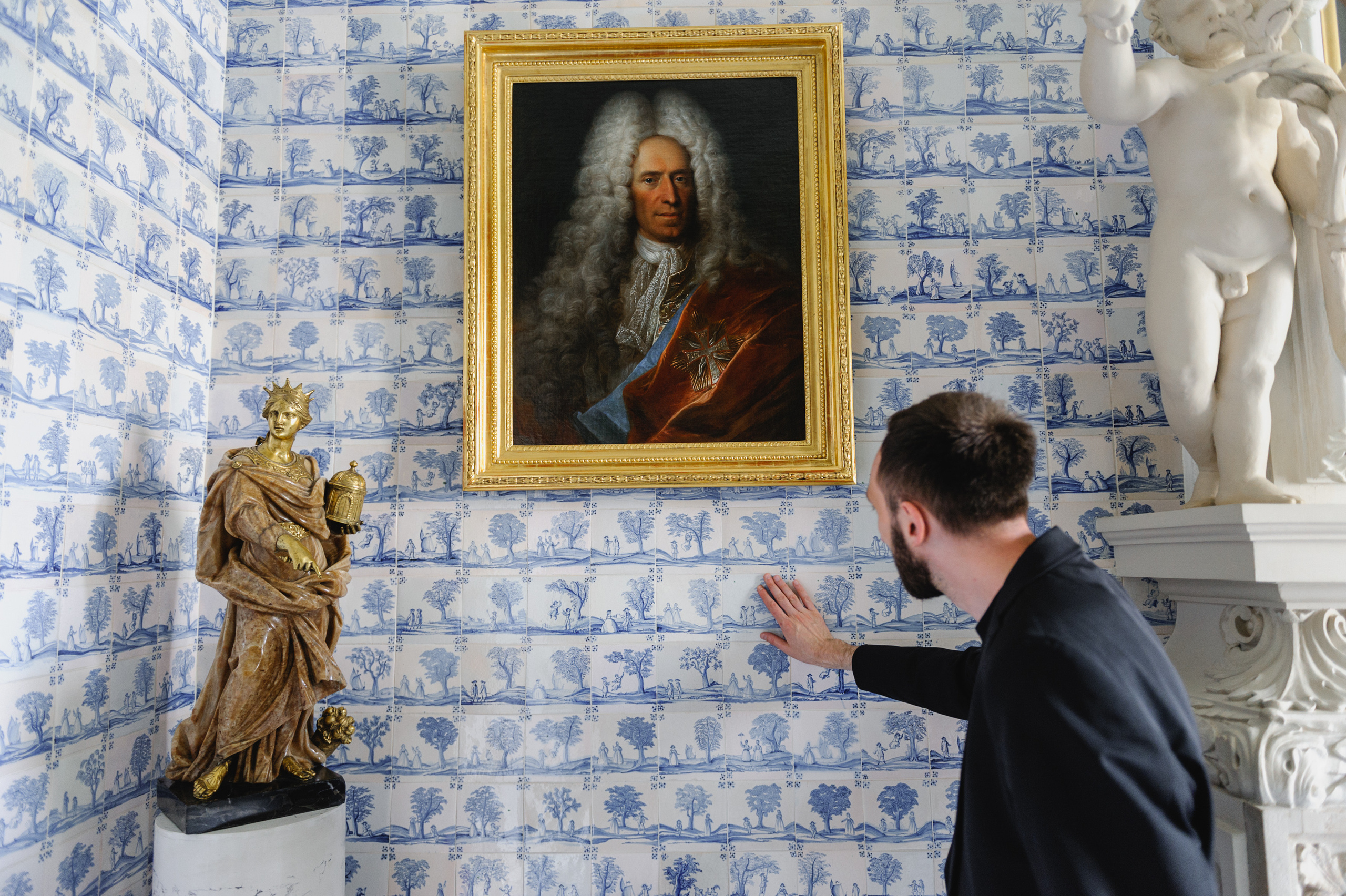 Art historian Dmitry Solodkiy touches a tile. The Royal Baths Museum in Warsaw.