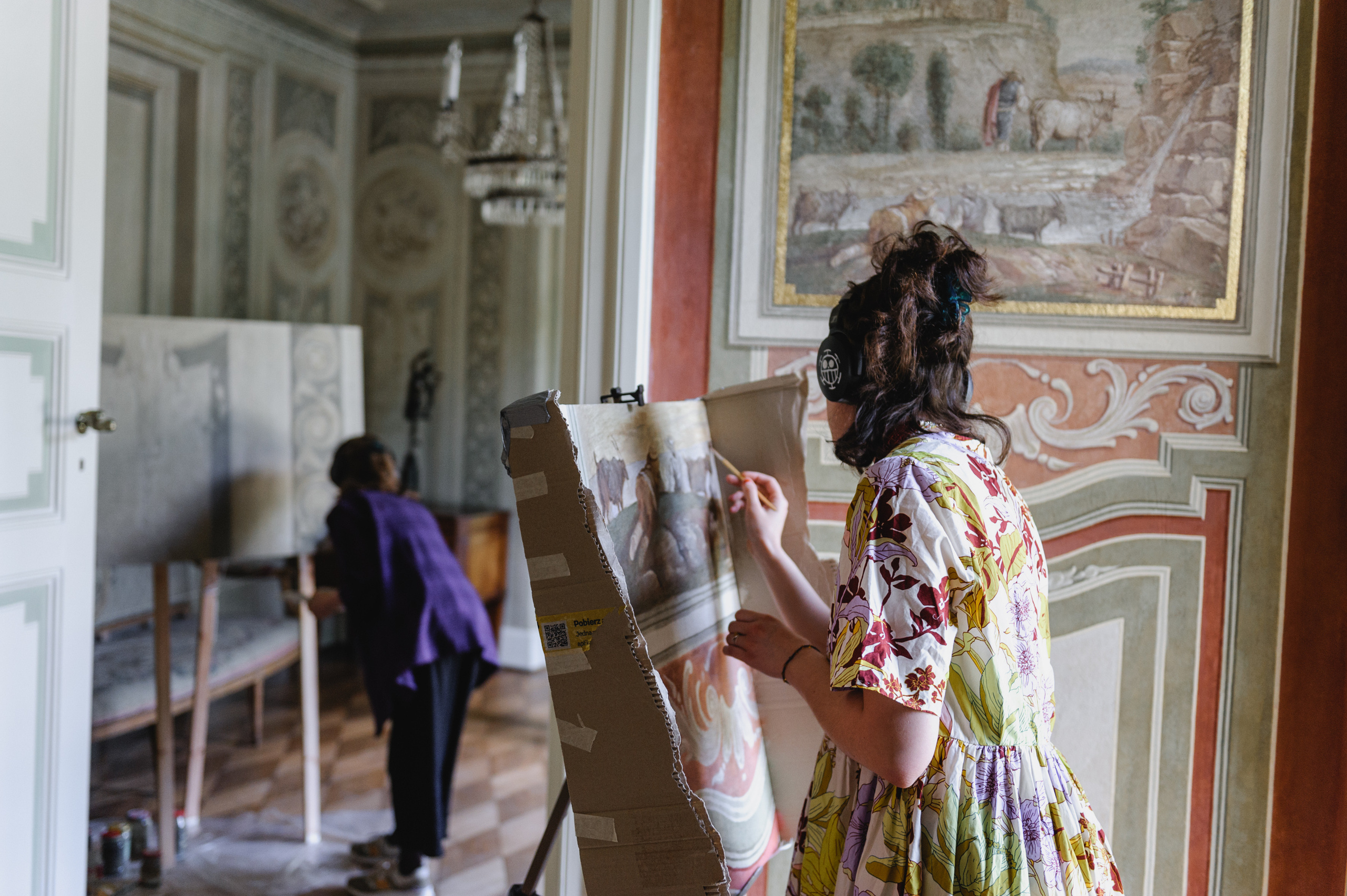 Female artists painting artworks. The Royal Baths Museum in Warsaw.
