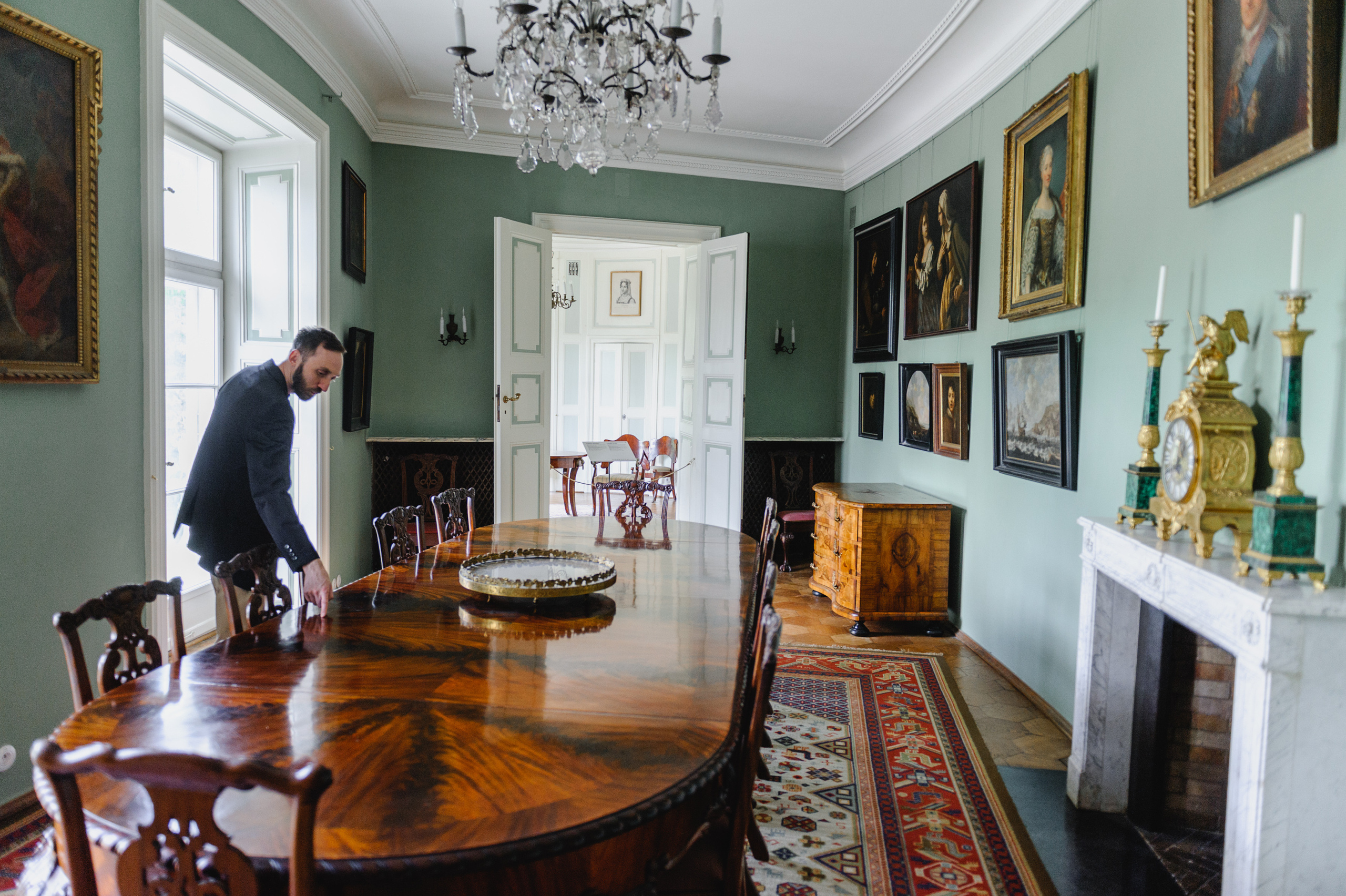 Cultural scholar Dmitry Solodkiy touches a table. The Royal Baths Museum in Warsaw.