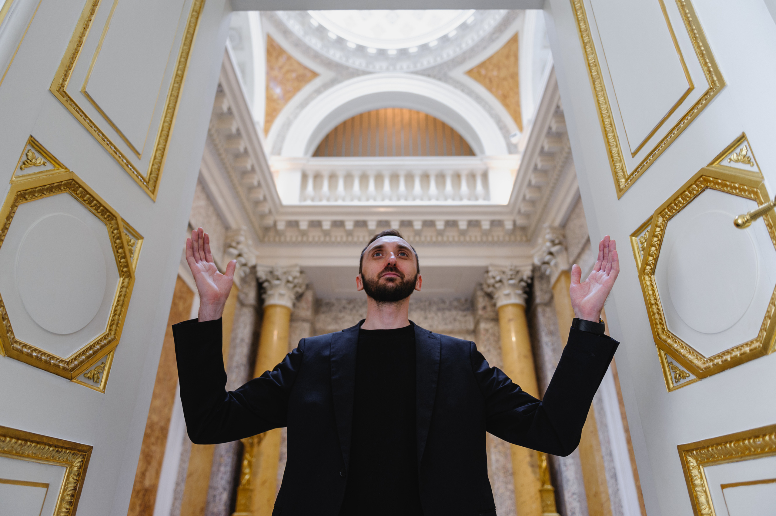 Art historian Dmitry Solodkiy resembling a saint. The Royal Baths Museum in Warsaw.Chandelier, view from below. The Royal Baths Museum in Warsaw.
