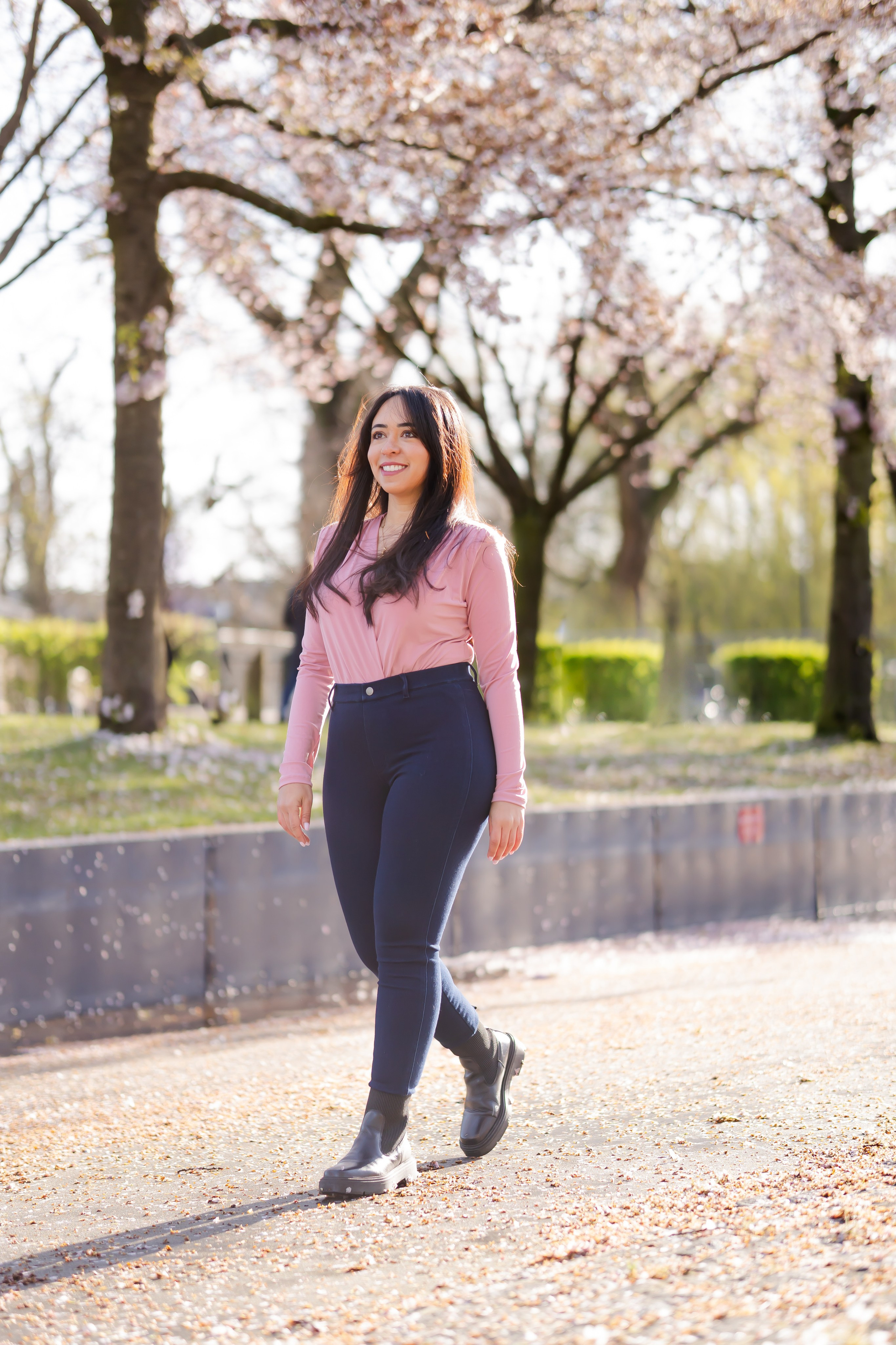 girl walking in a cherry blossoms garden in Netherlands