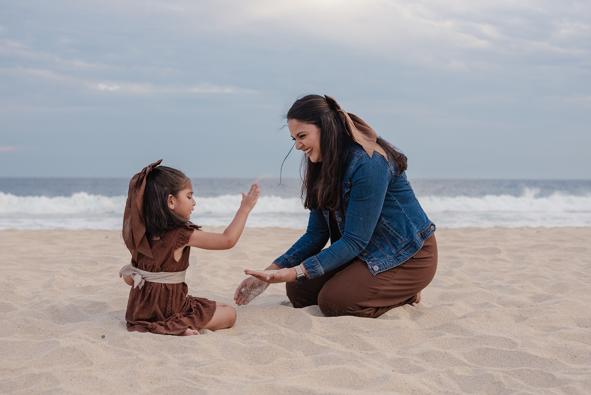 Mother and daughter sharing a playful moment on the beach at Hyatt Ziva Los Cabos