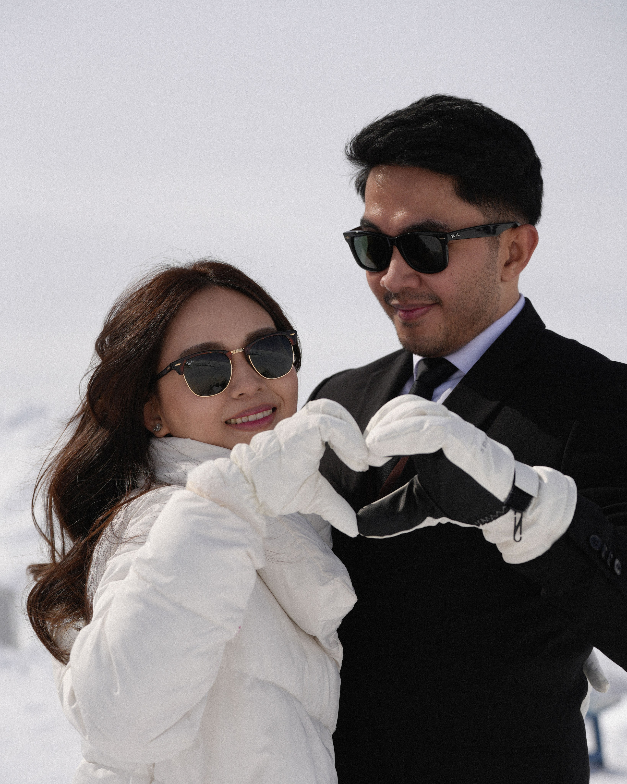 Bride and groom holding hands on the ski slope in Georgia