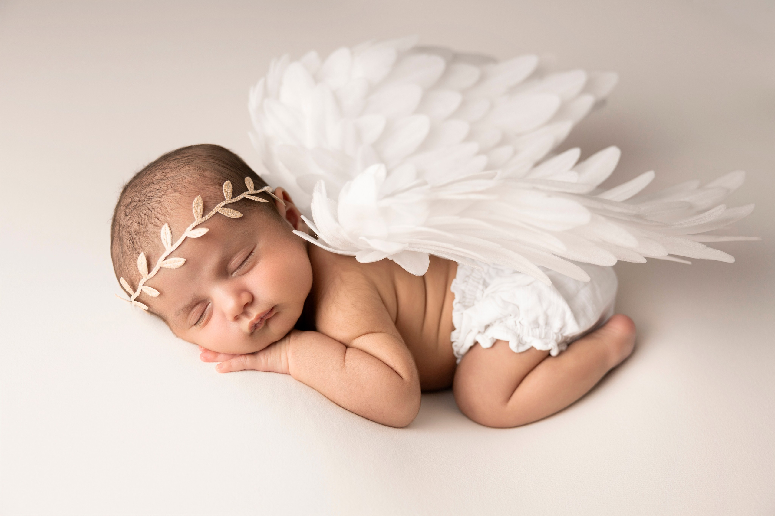 newborn with white angel wings