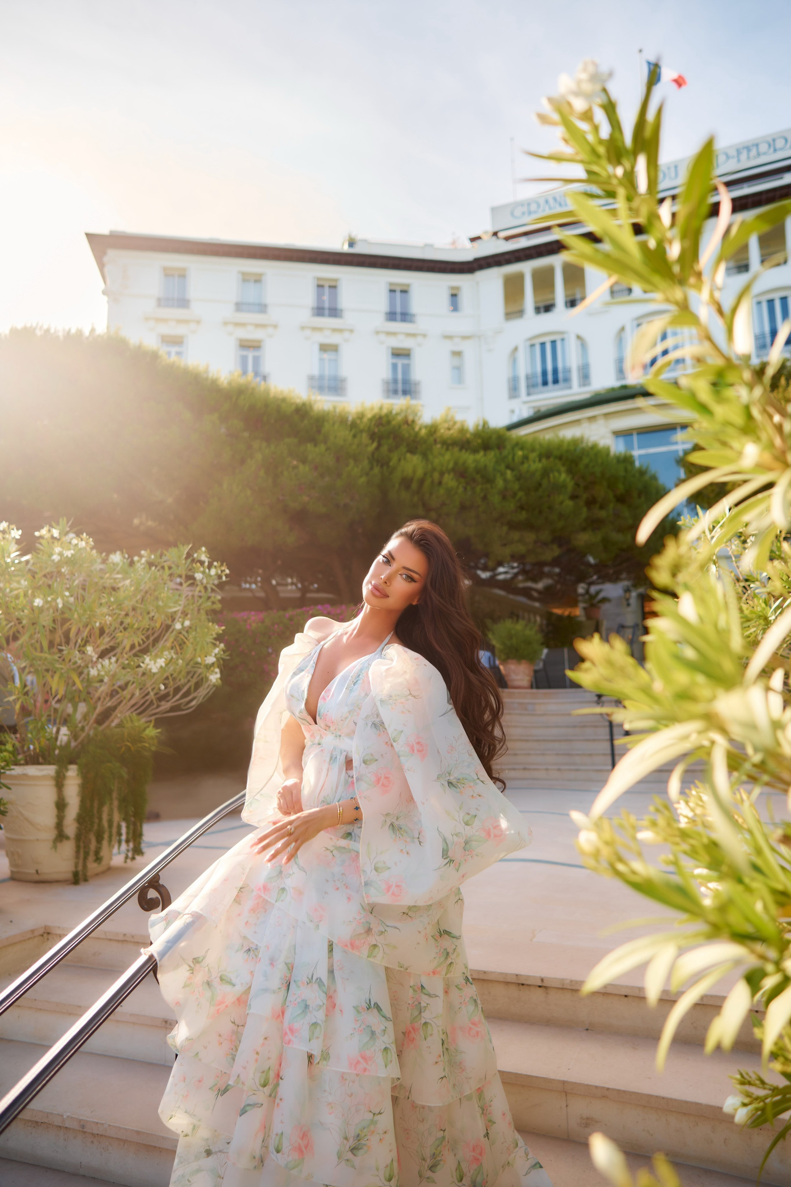 Glamorous photo of woman standing near Grand Hotel Cap Ferrat facade French Riviera