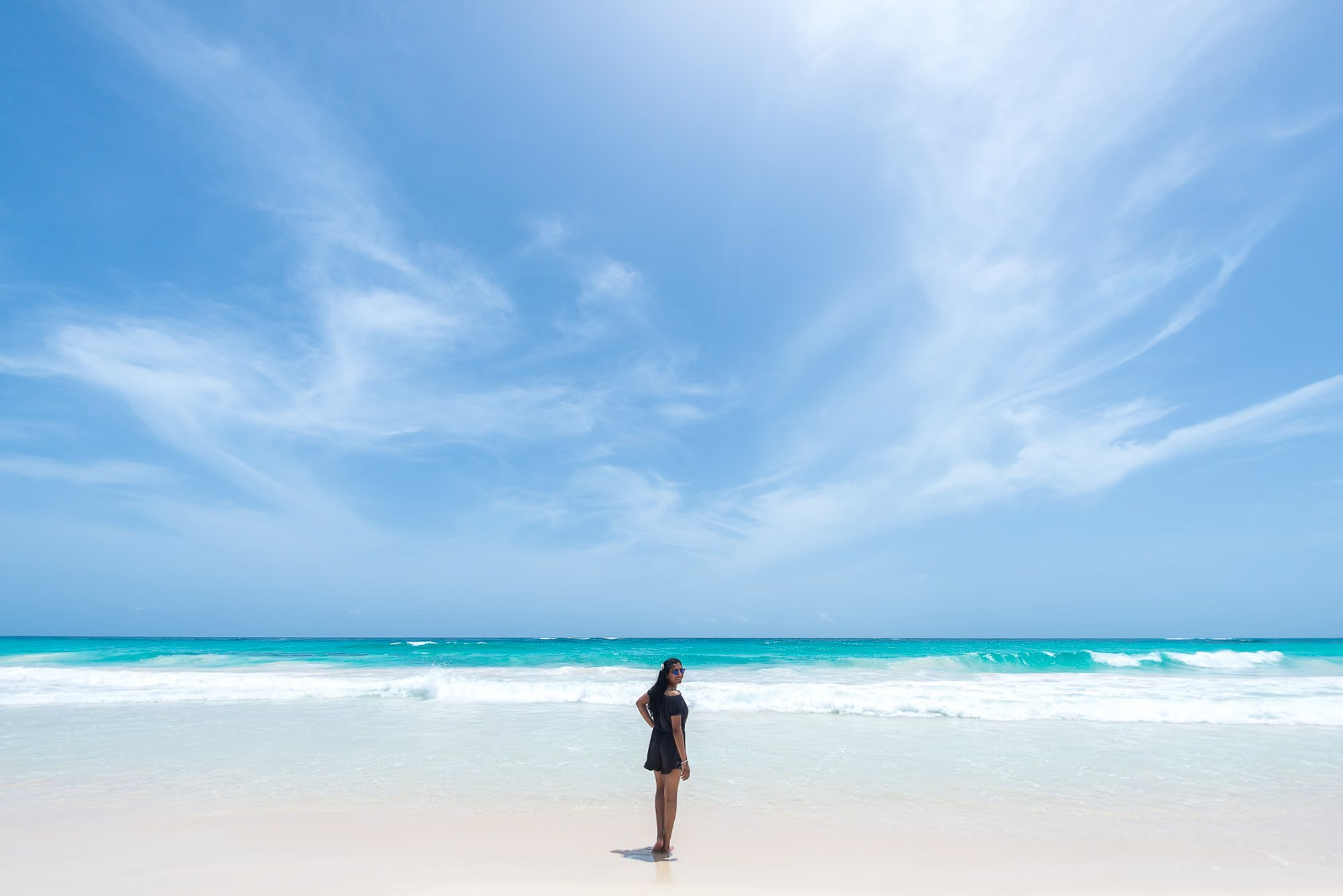 Elegant portrait of a woman by the turquoise Caribbean Sea in Punta Cana.