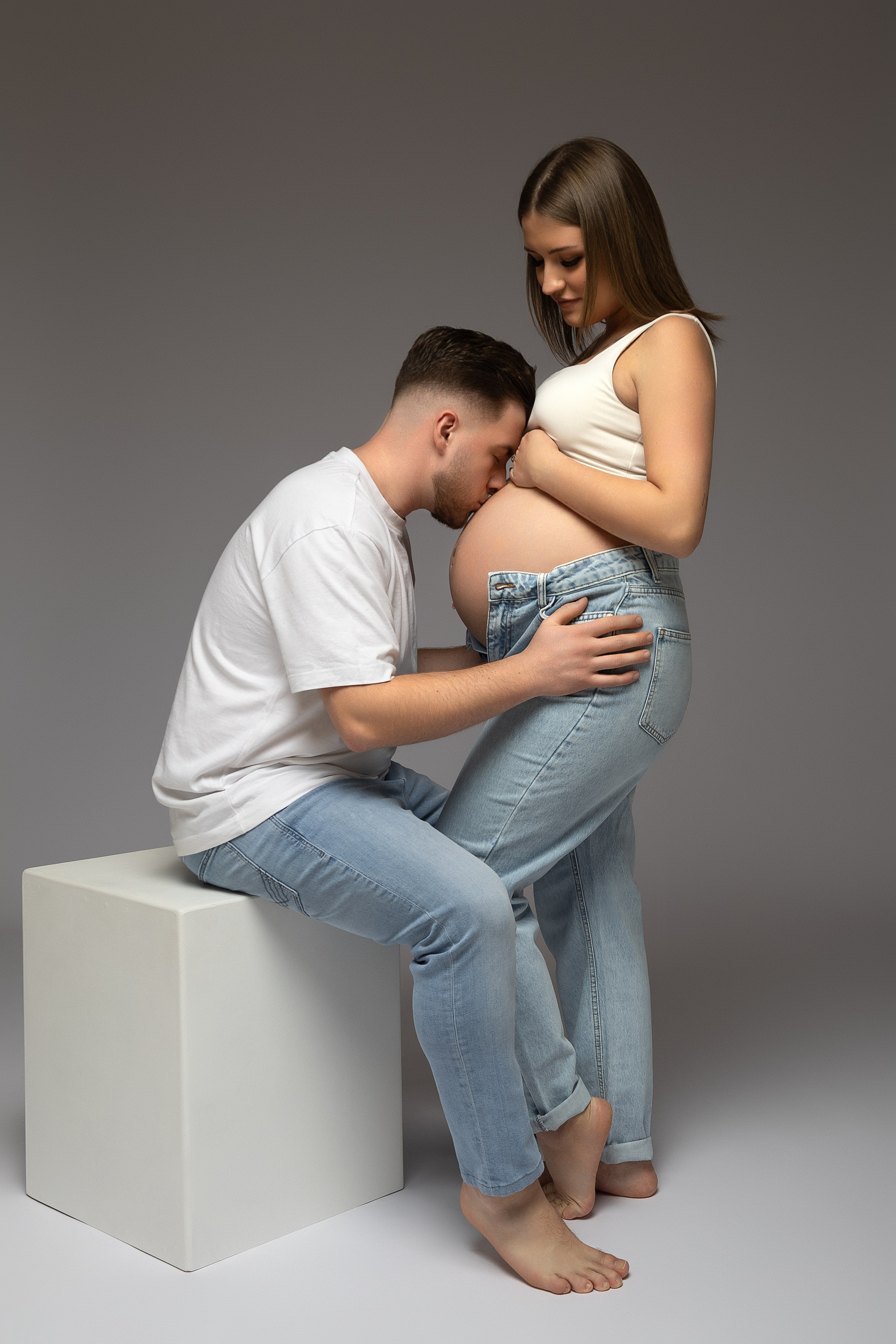 Werdende Mama Celina und Papa Etrit in weichem Licht 