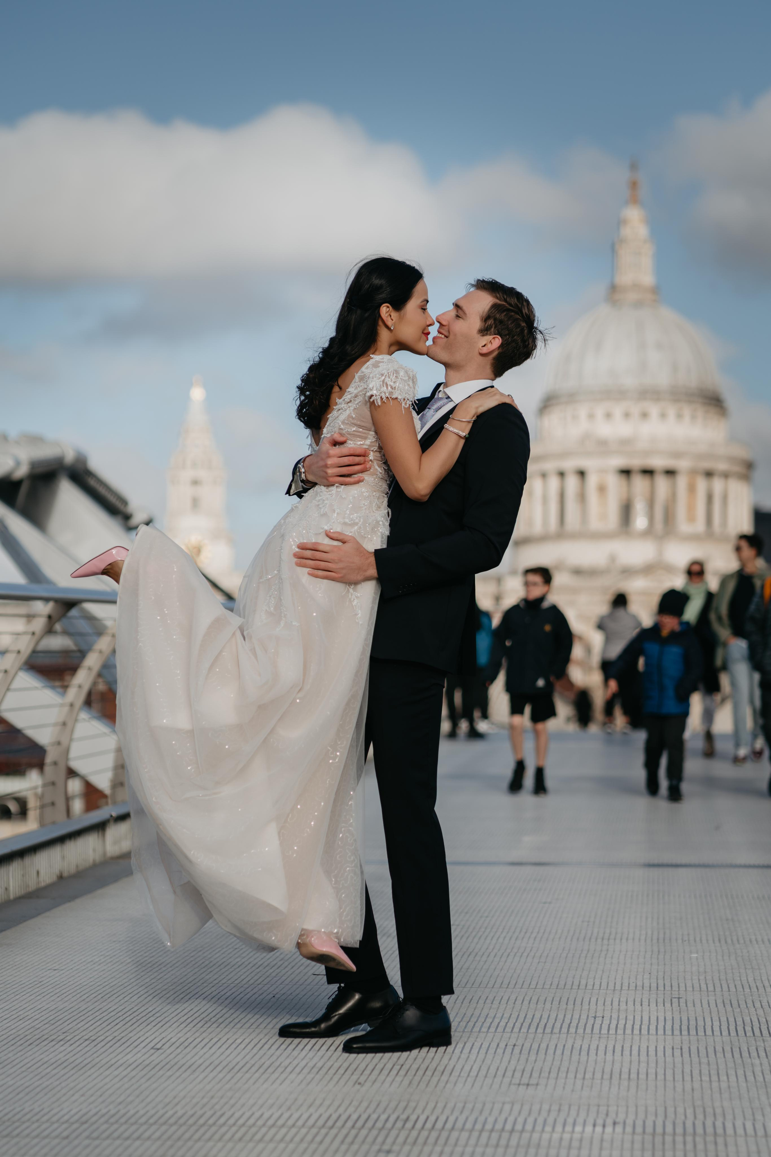 groom lifting bride after wedding ceremony 