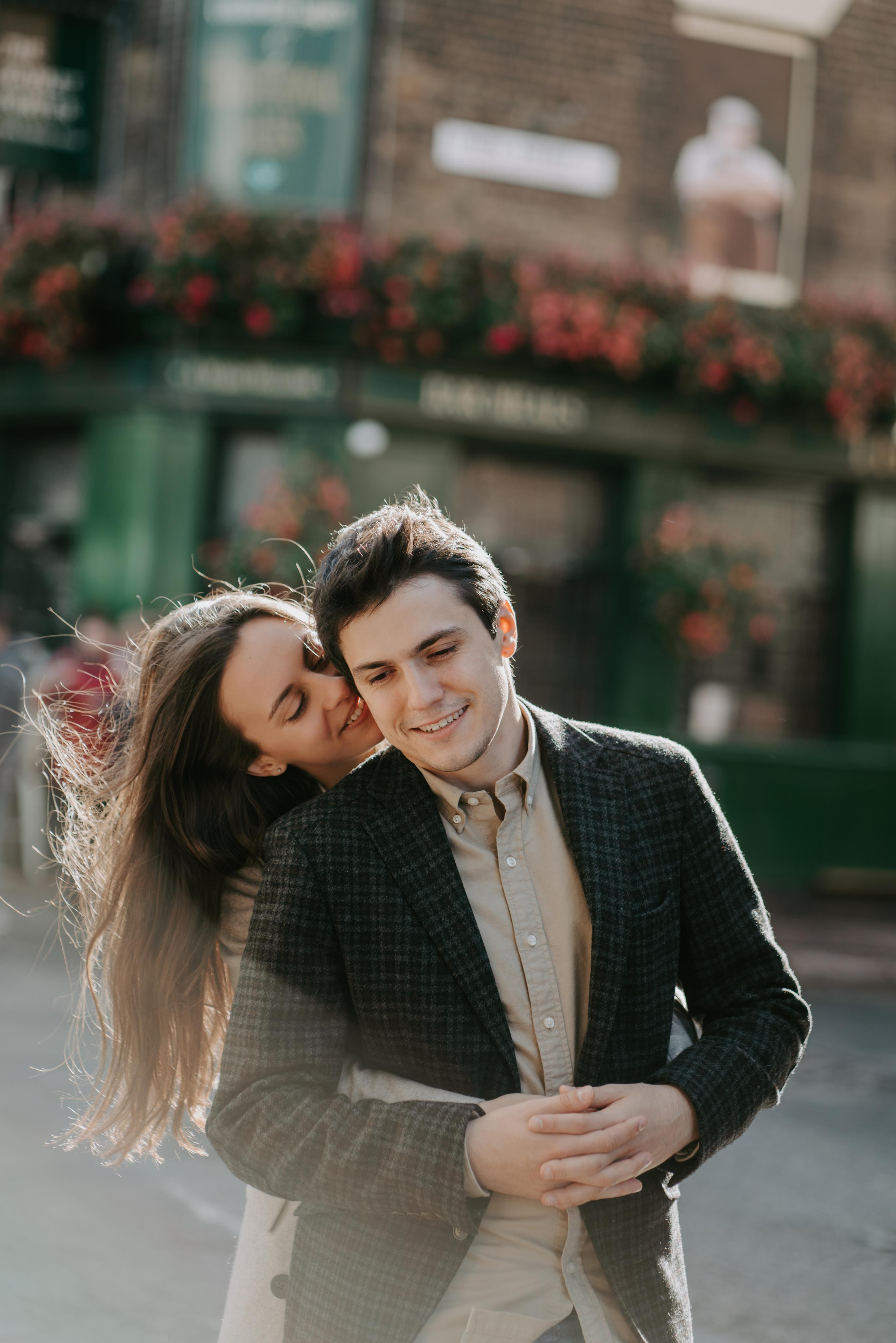 young women hugging from behind 
