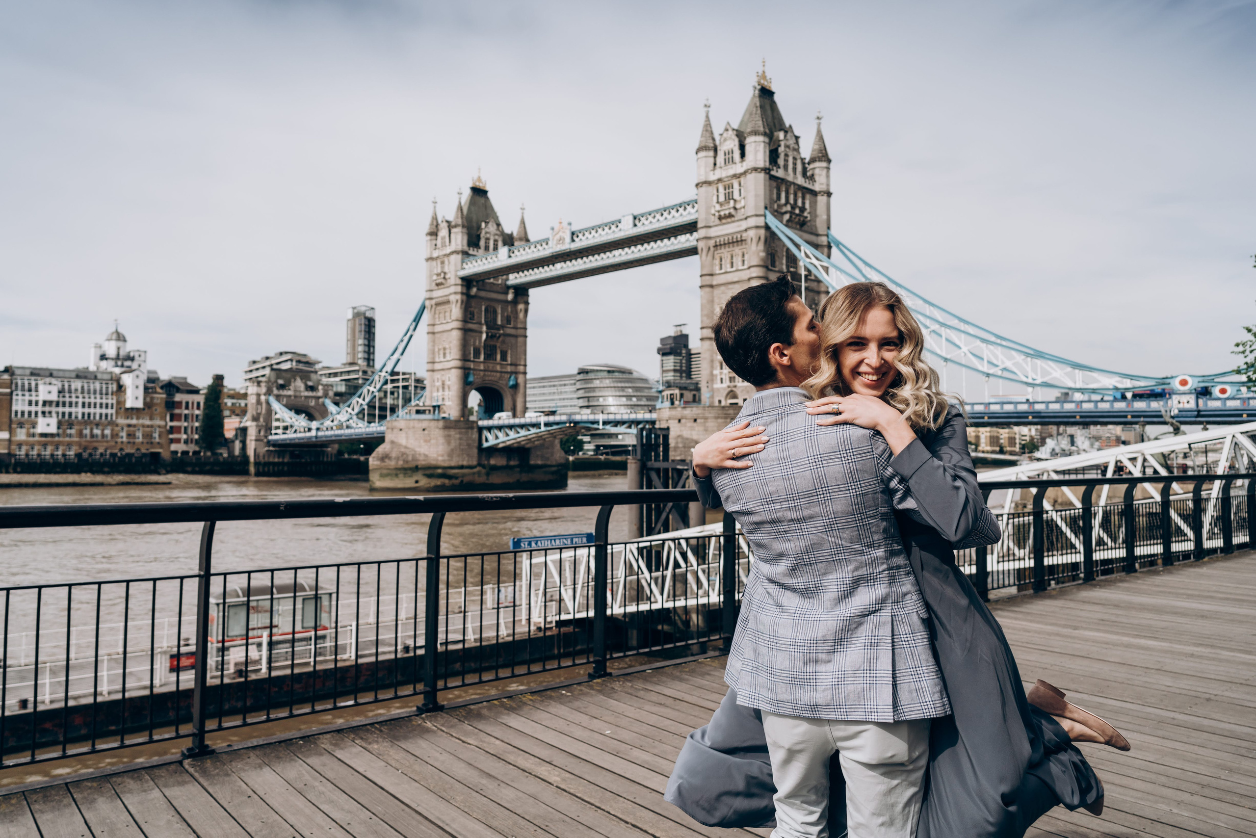young women laughing when young man kissing her neck 