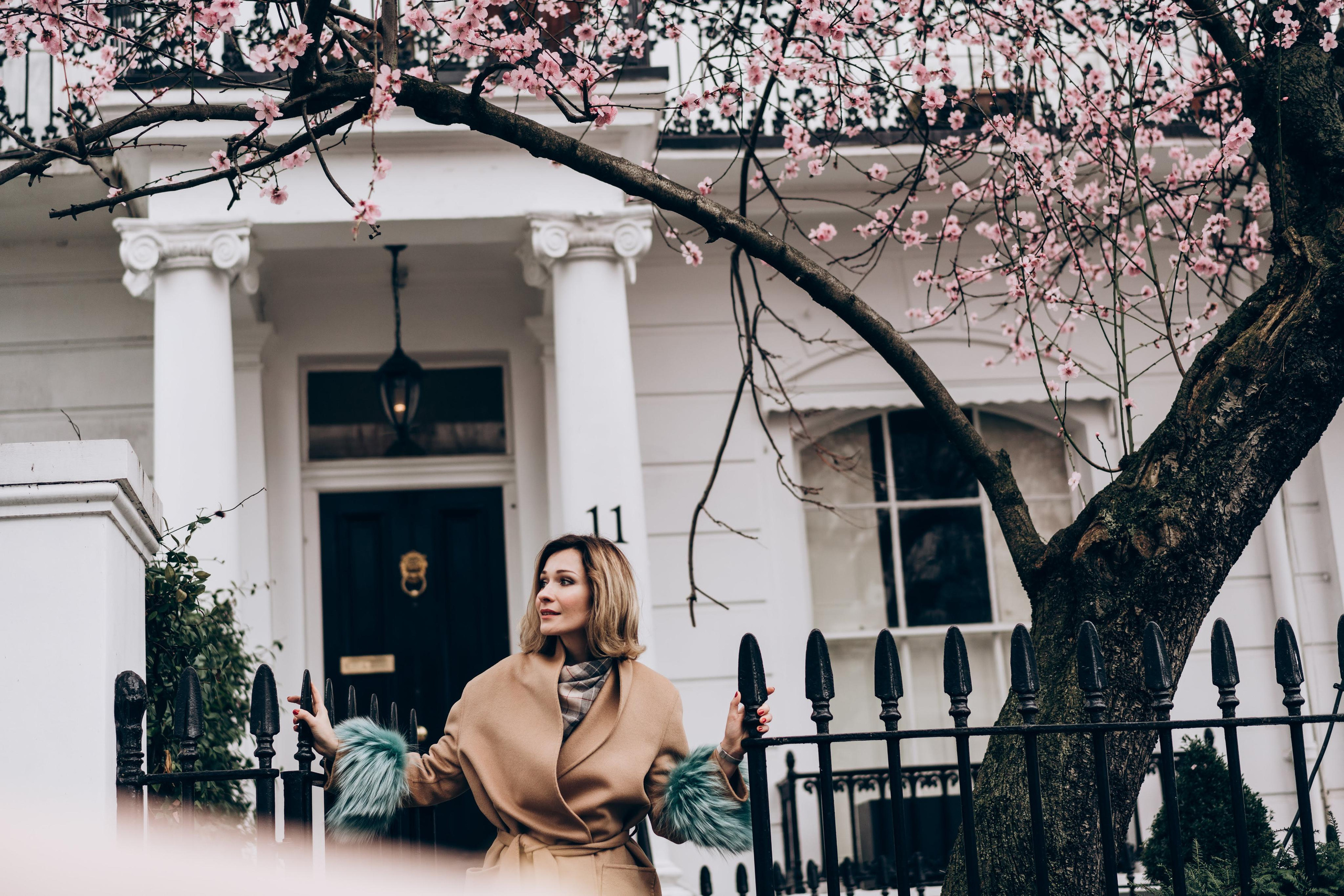young women posing by the blooming tree