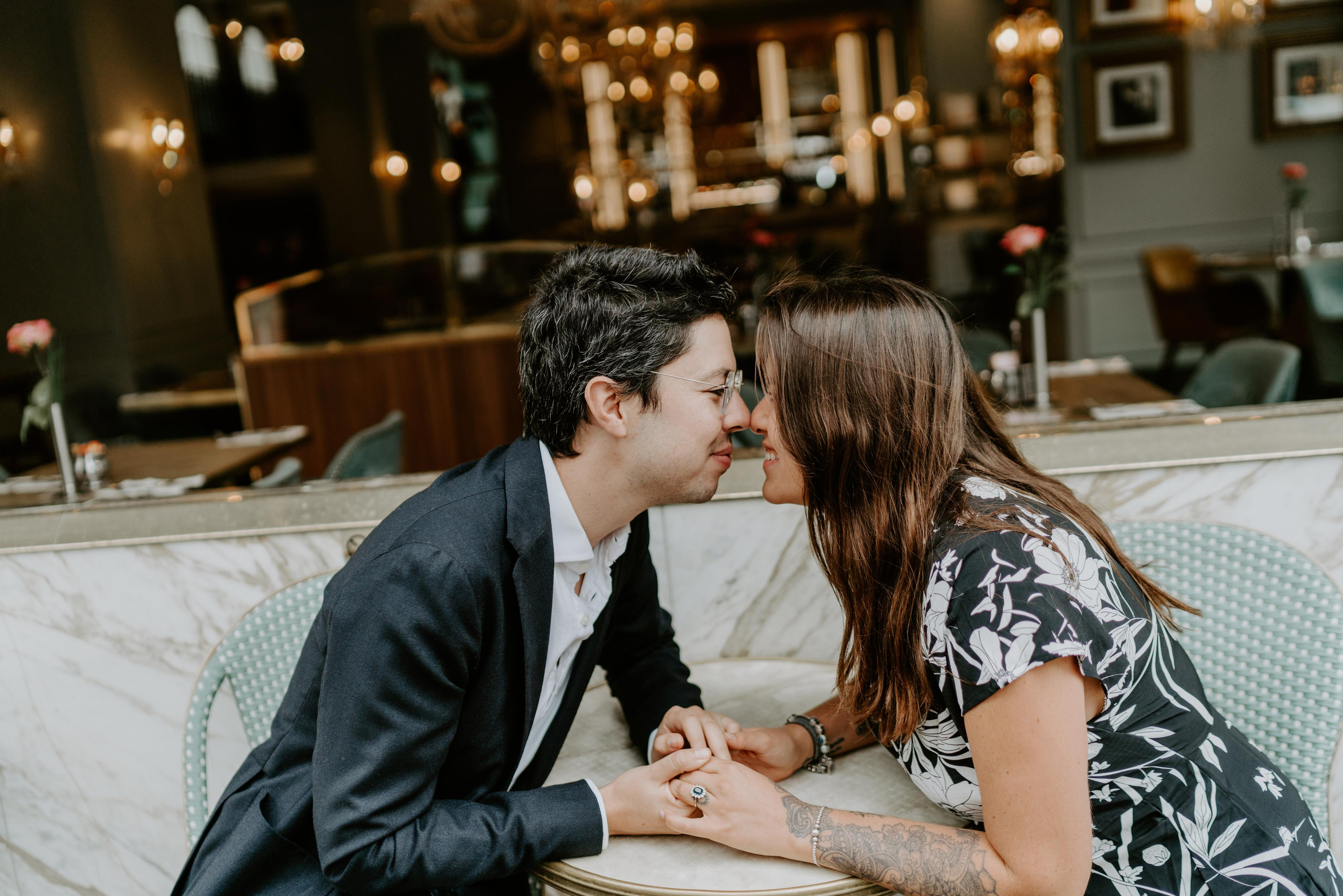 young couple kissing by the table 
