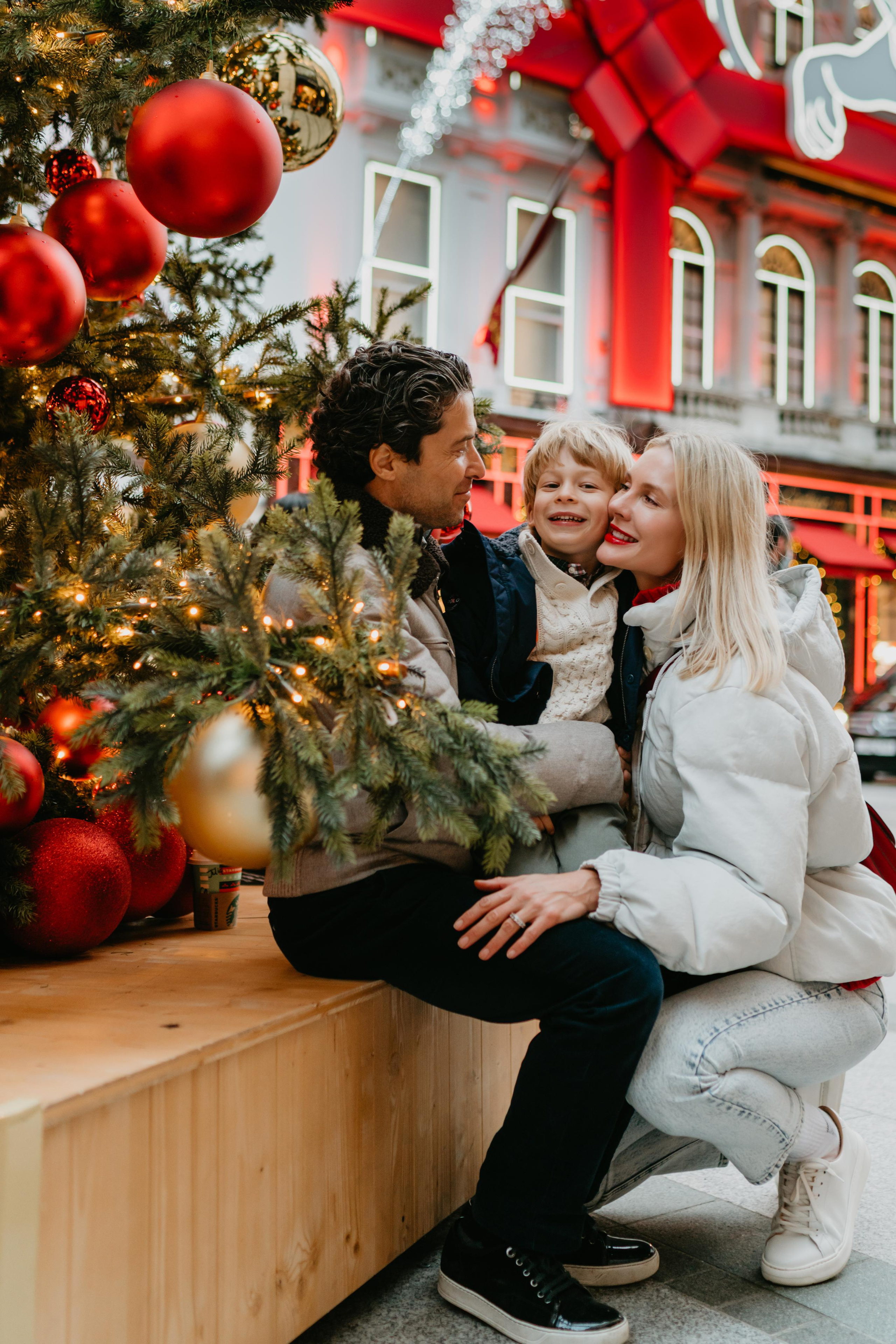 family hugging under Christmas tree