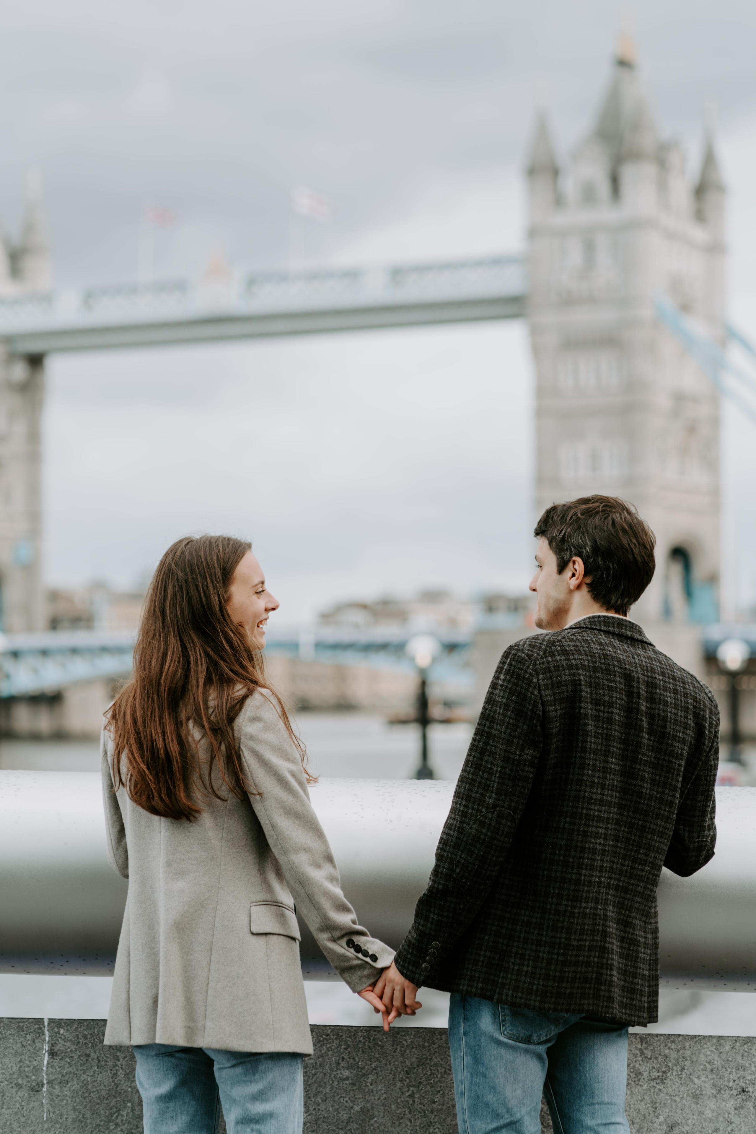 young couple looking at tower bridge 
