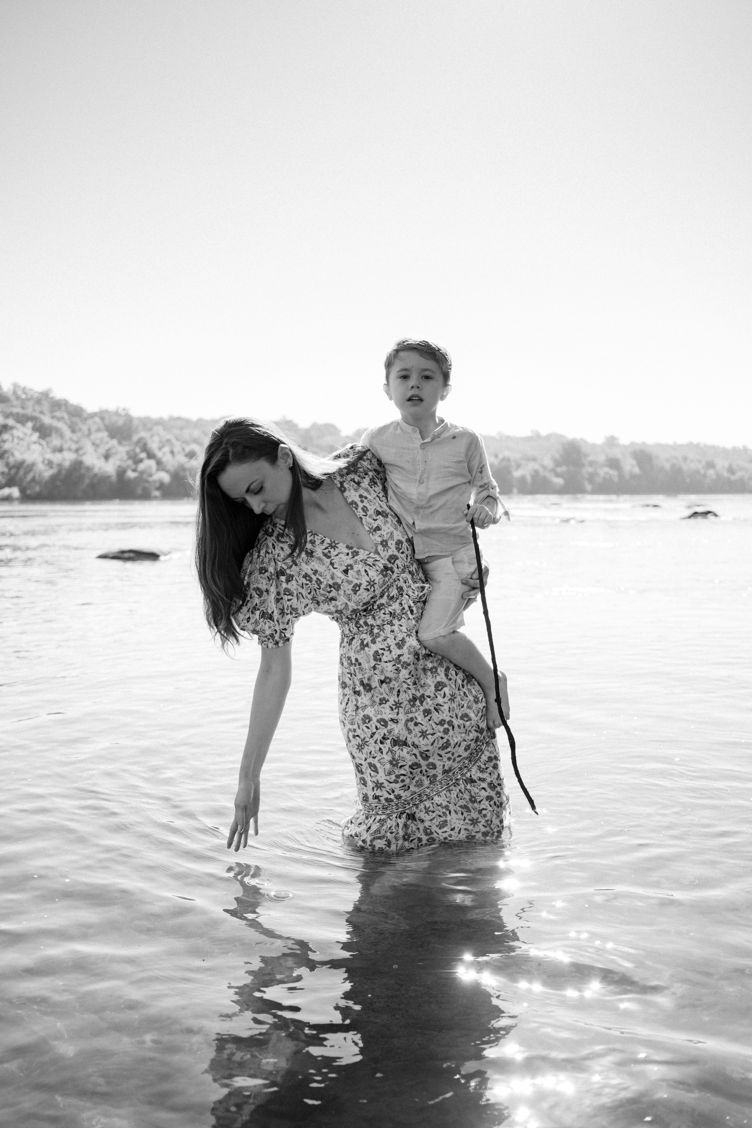 An adventurous family silhouette against the beautiful morning sunlight reflecting off the James River