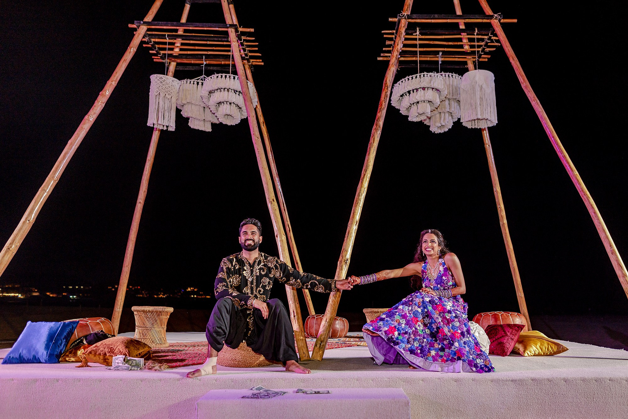 Paradisus Los Cabos Indian wedding – couple holding hands under floral decor during multi day celebration