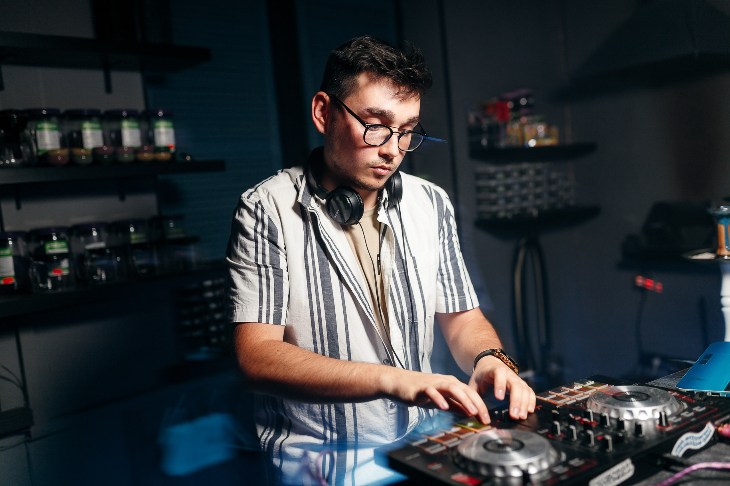 DJ mixing music at event, lively atmosphere