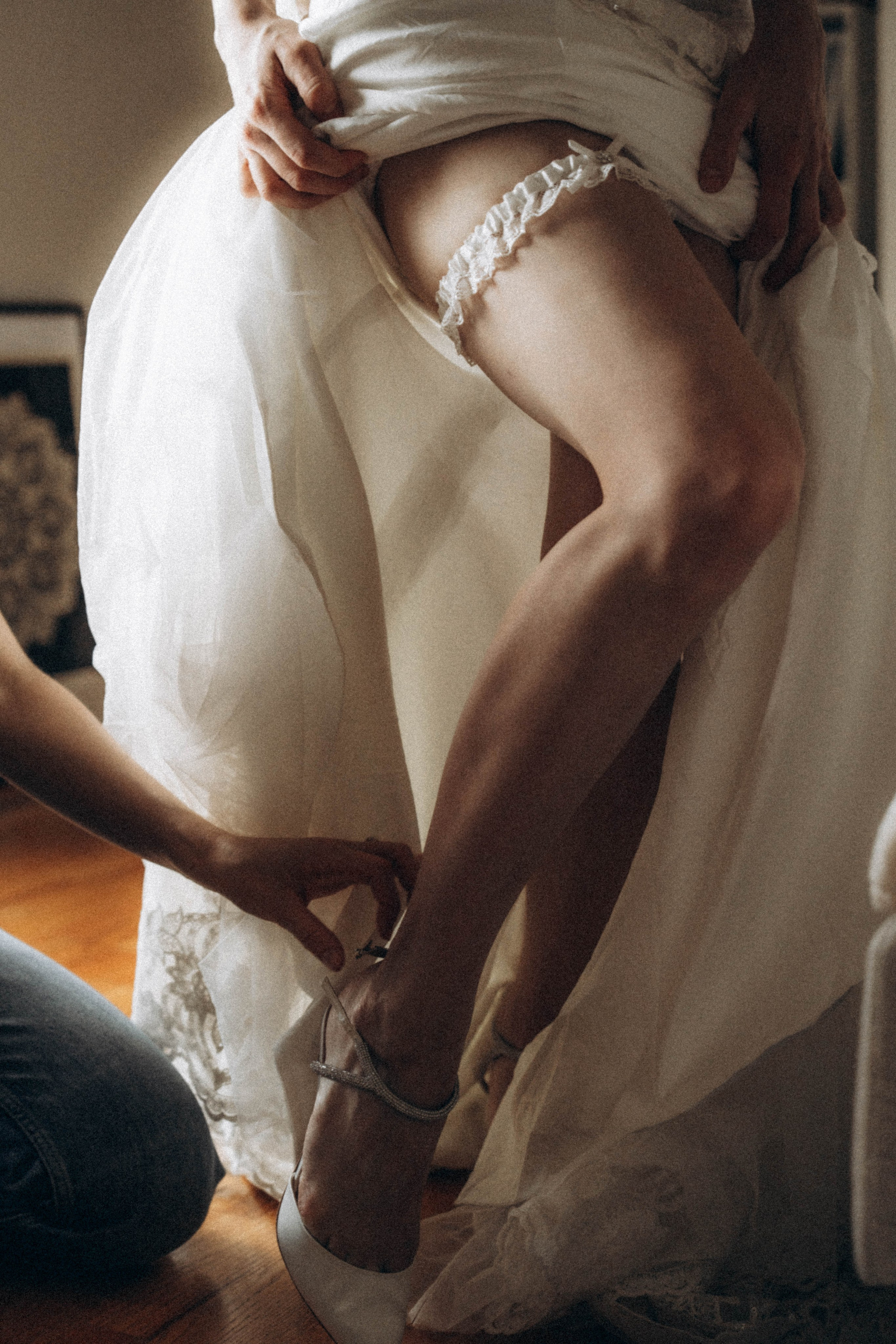 Bride leaning against stone wall in Kingston.