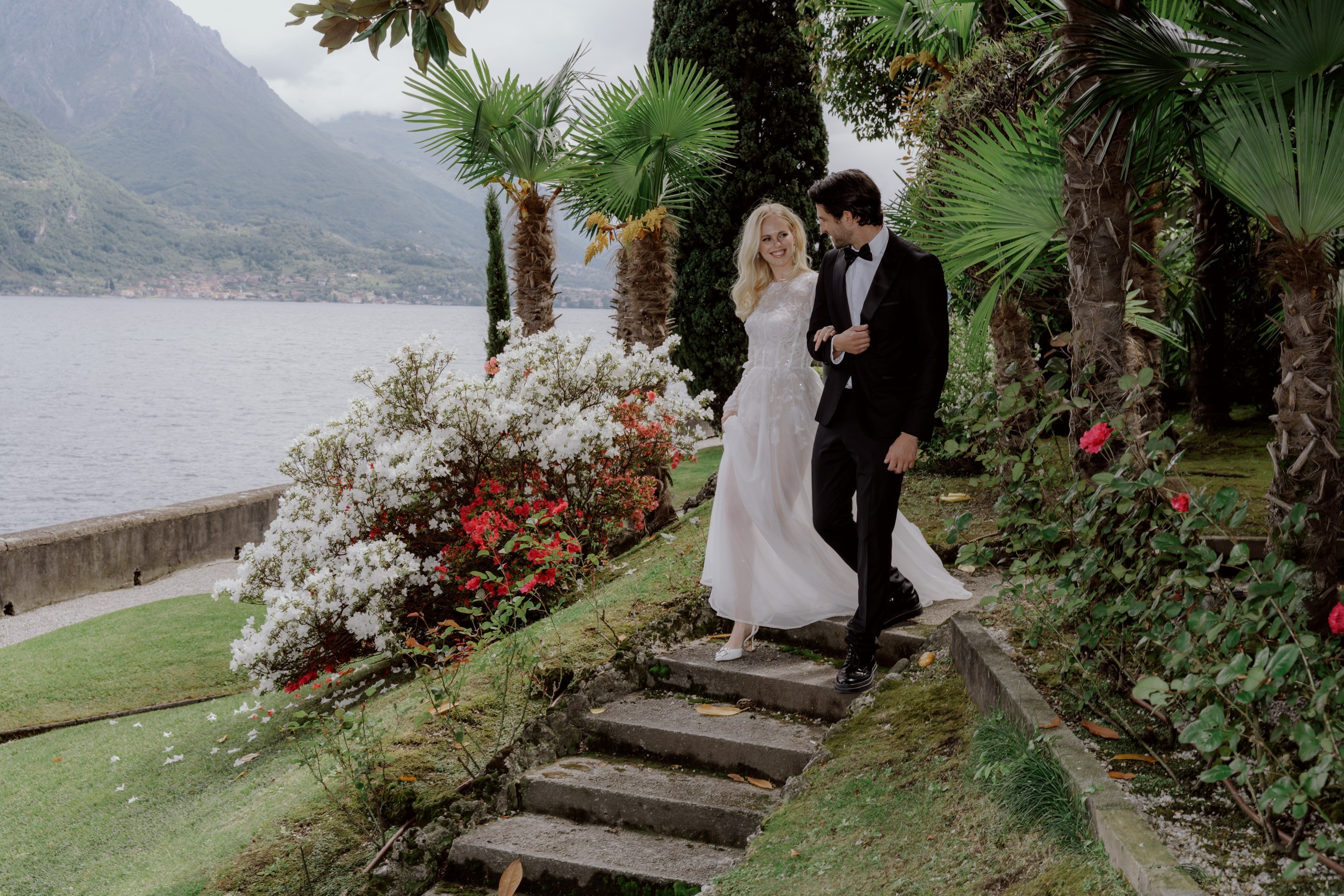 Bride and groom walking together in gardens of Villa Aura